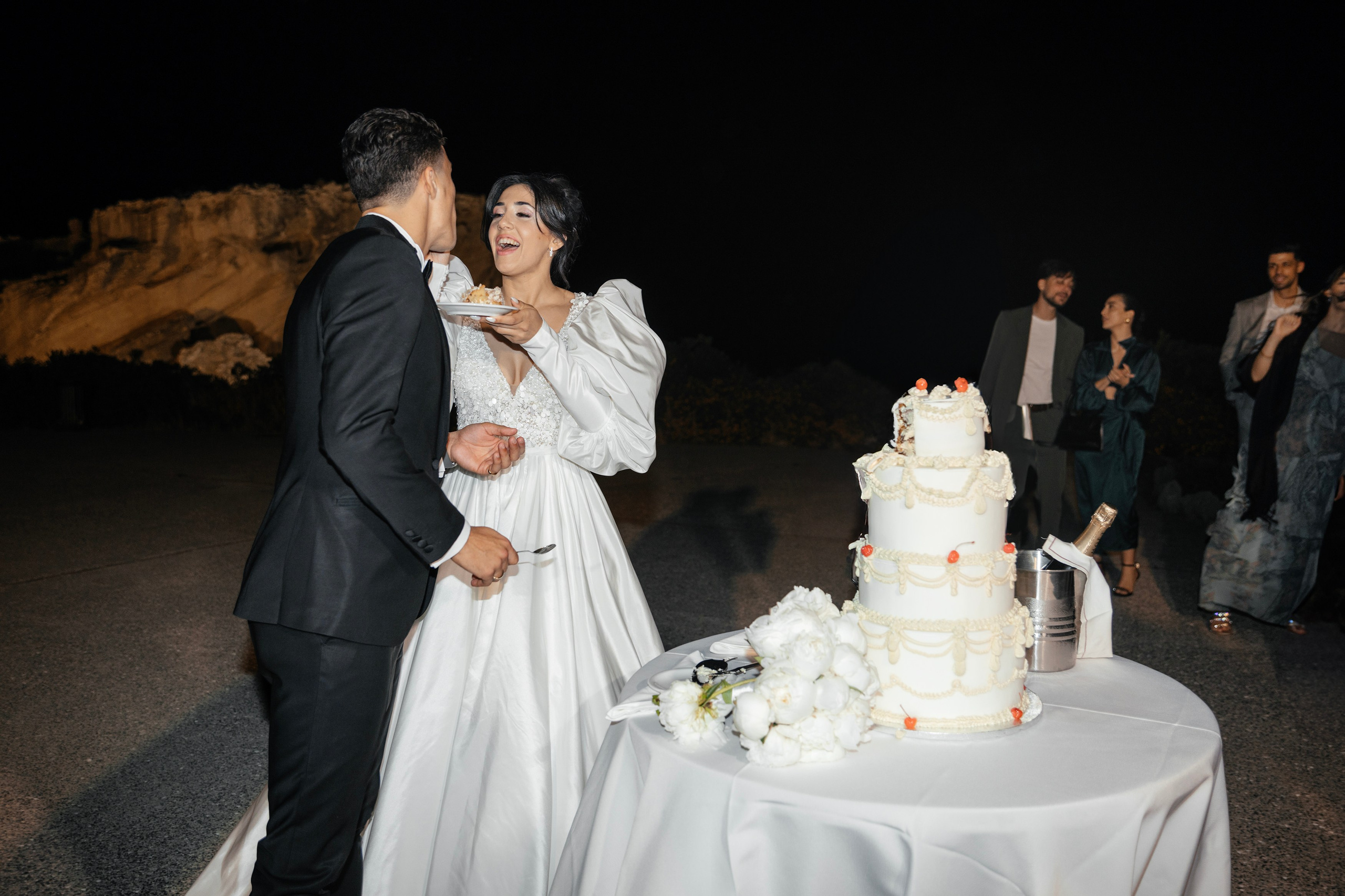Bride and groom are cutting and eating the wedding cake. Rhodes Greece