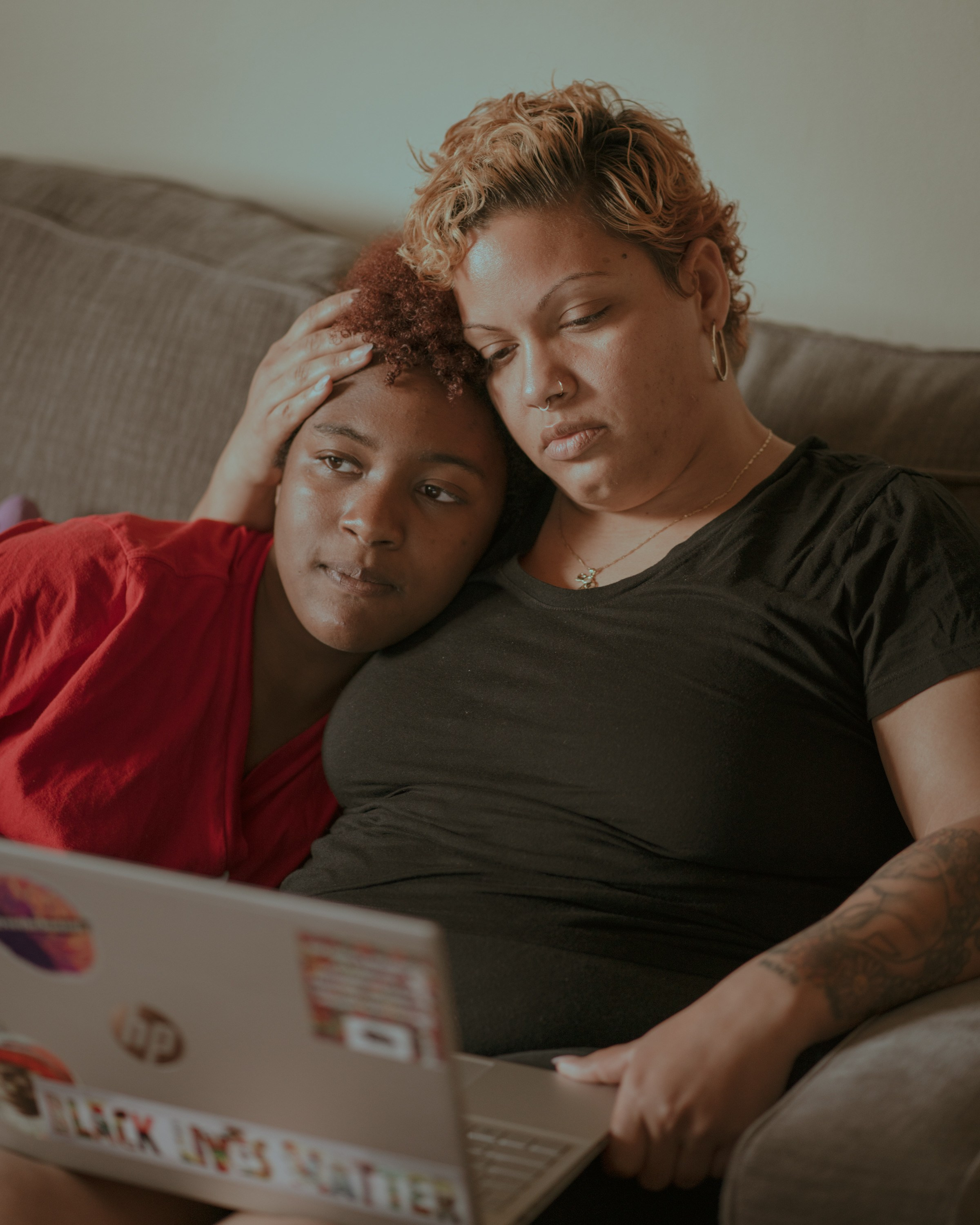 Emy is working on her final research paper for school. Her daughter Coco came over for a hug. 