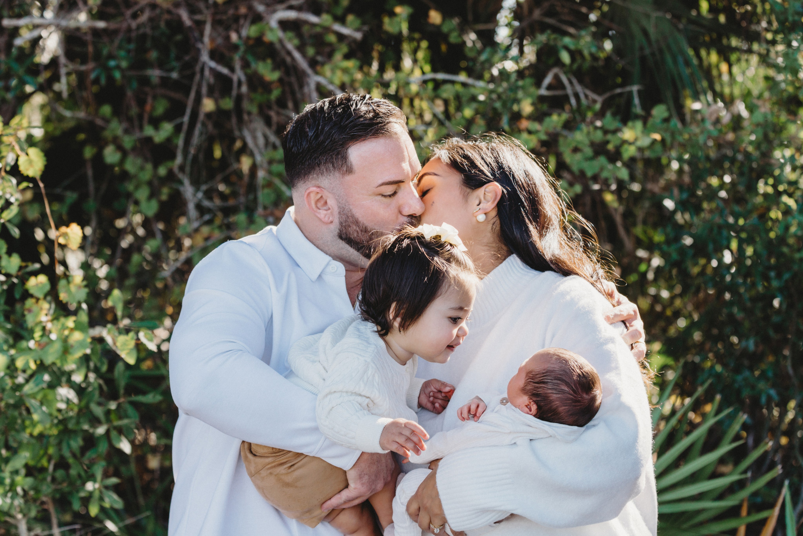 Portrait of kissing parents and two kids