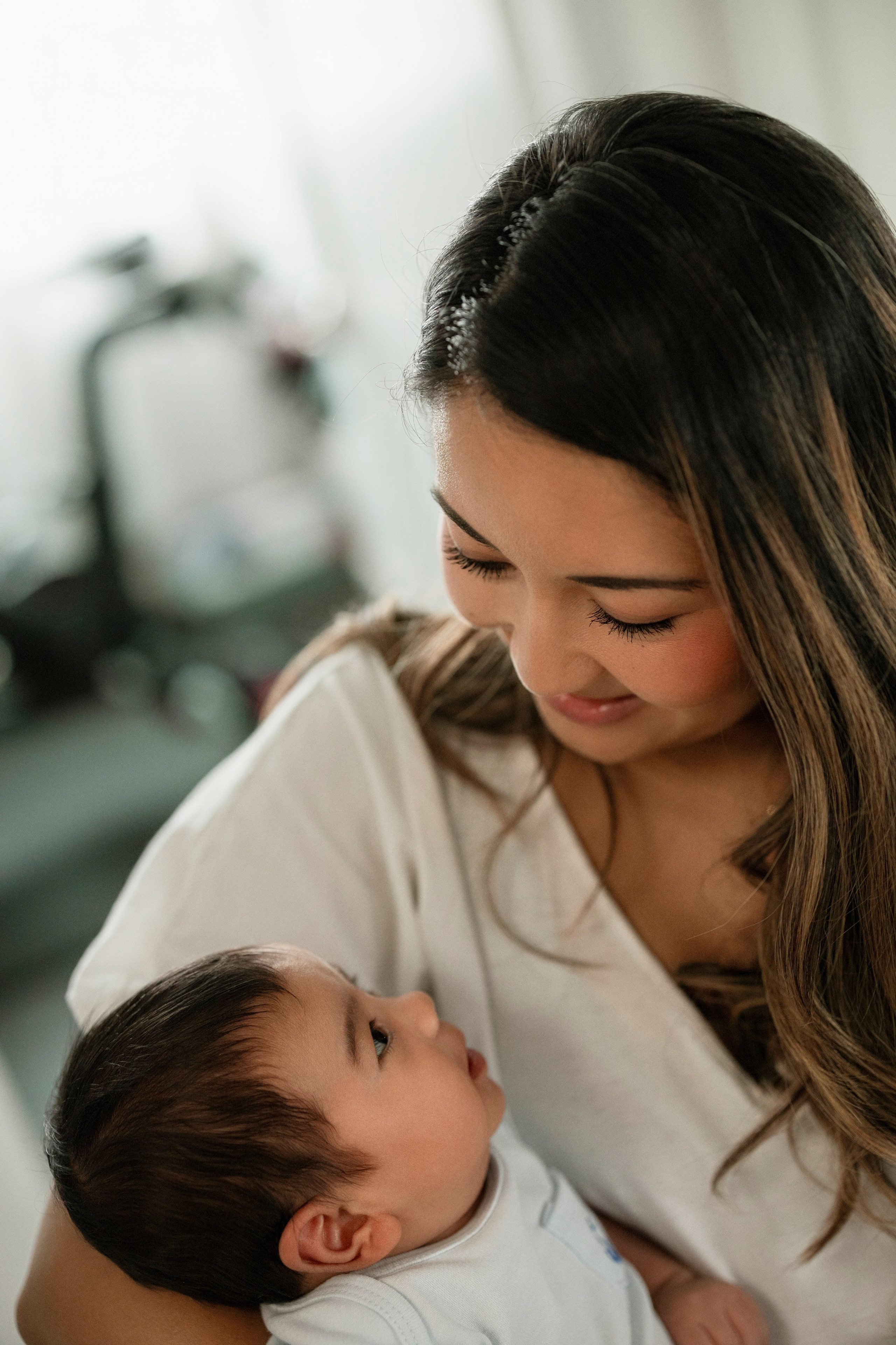 Mother holding newborn during lifestyle family photoshoot