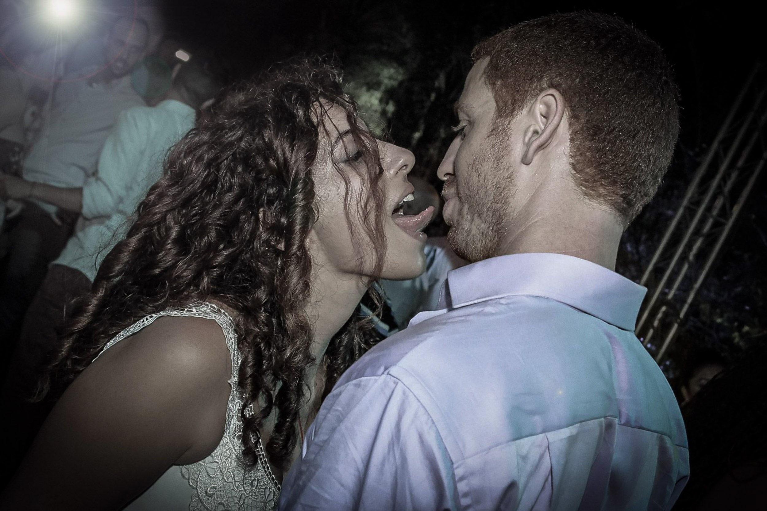 Bride and groom sharing a funny and passionate moment on the dance floor during a wedding in Israel