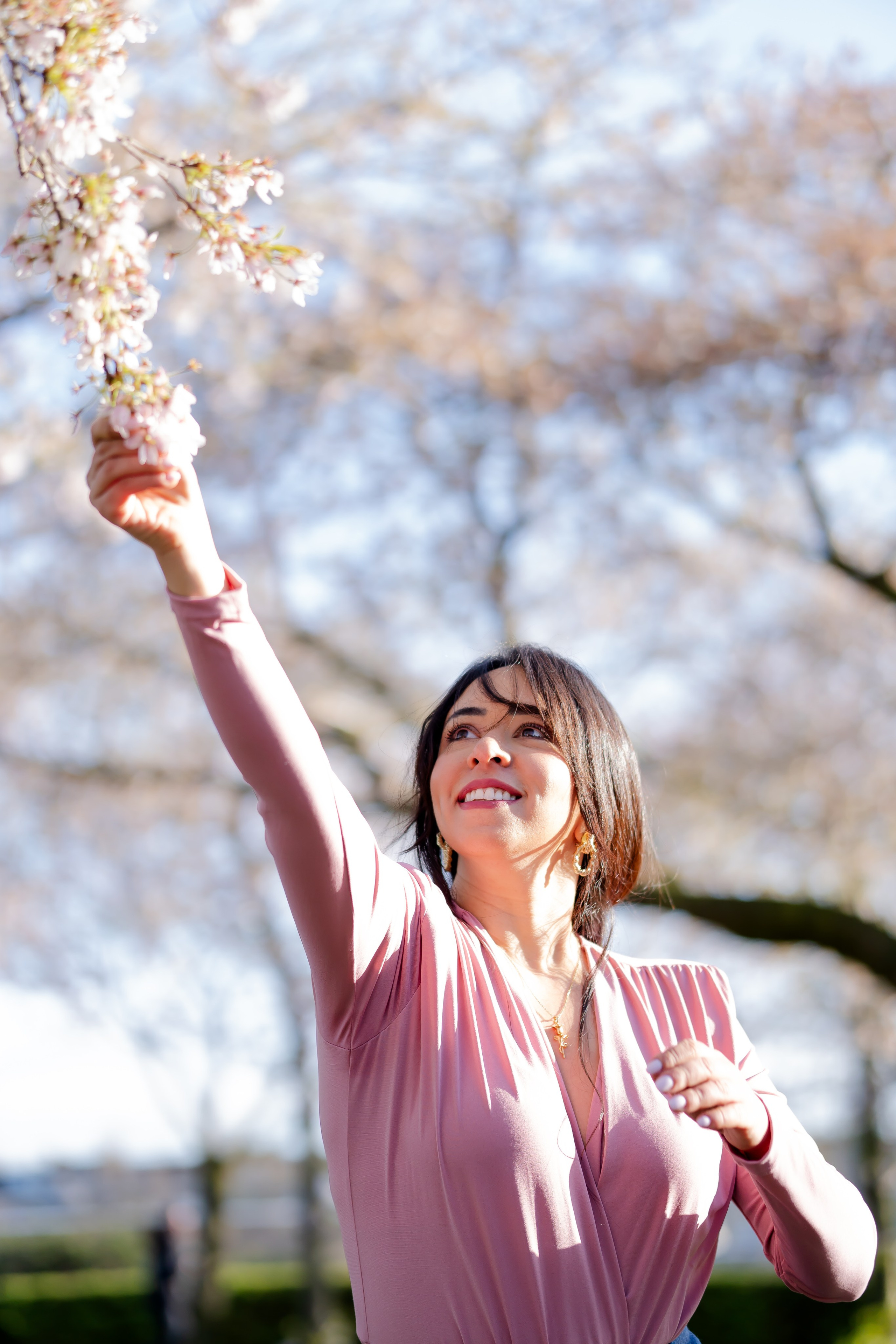 girl holding a cherry blossoms branch