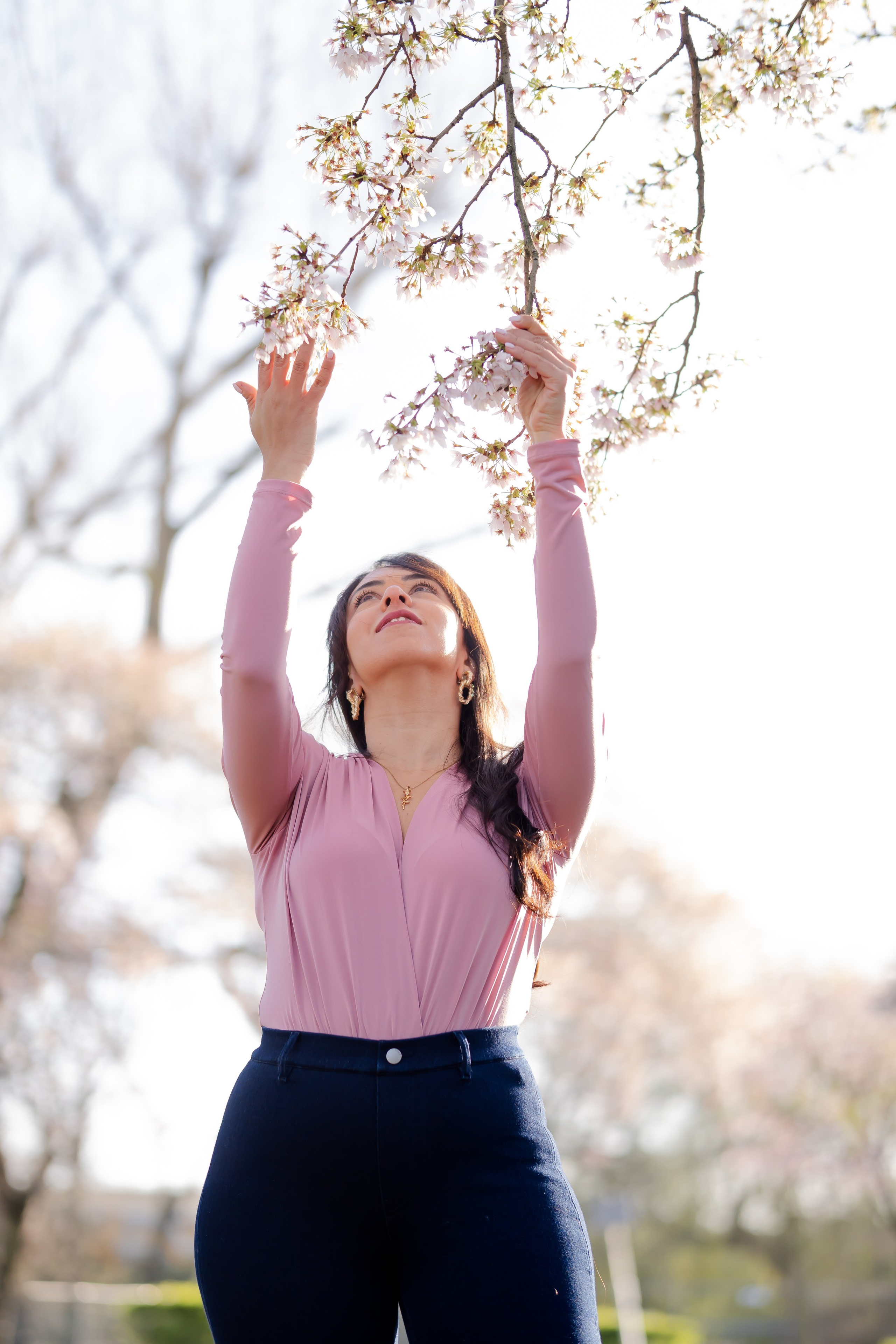 girl holding a cherry blossoms branch