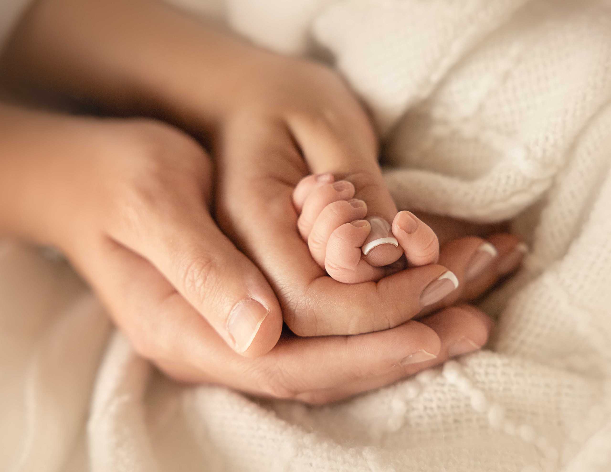 newborn hand in parents hands