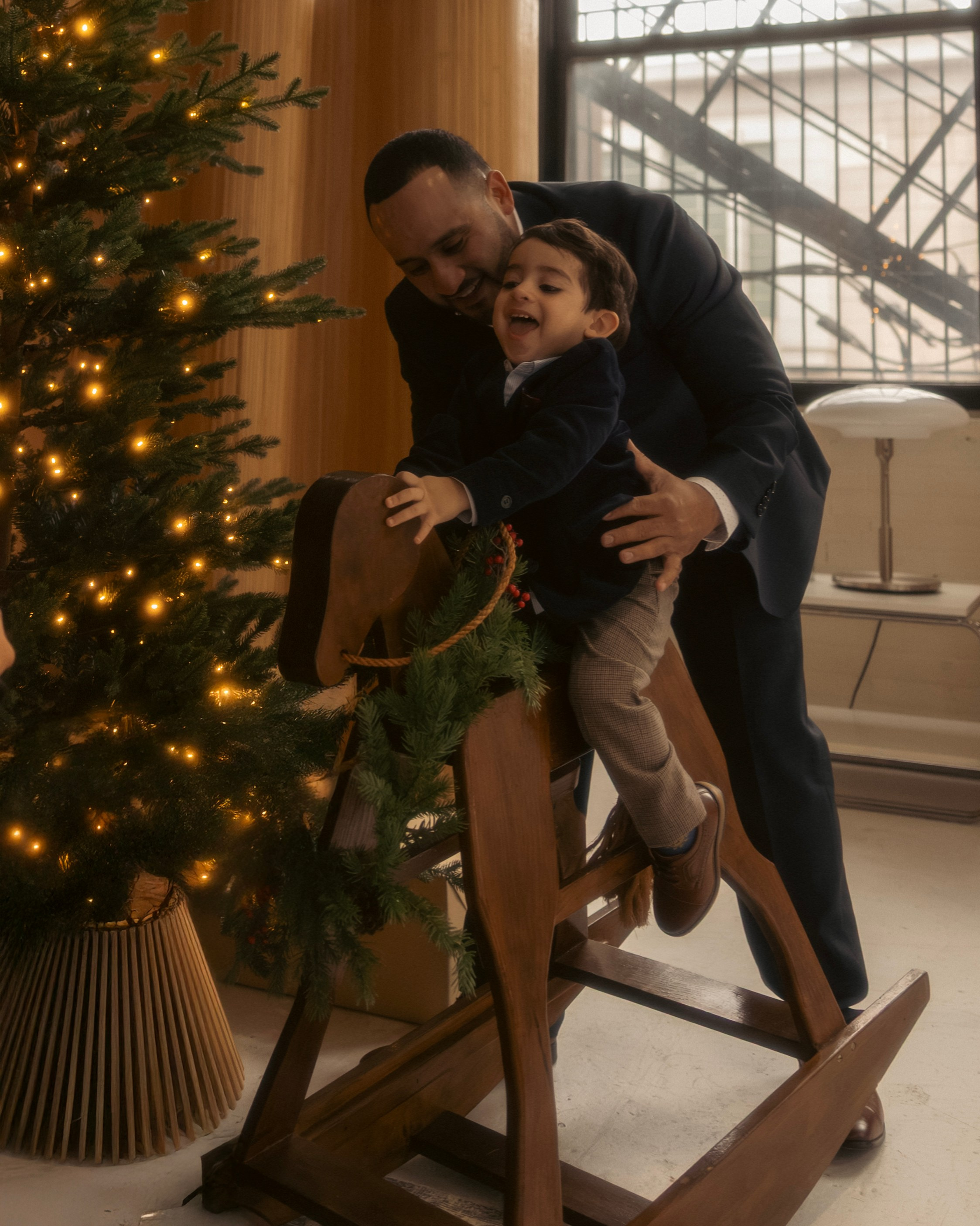 Family sitting by Christmas tree during Chicago holiday mini shoot