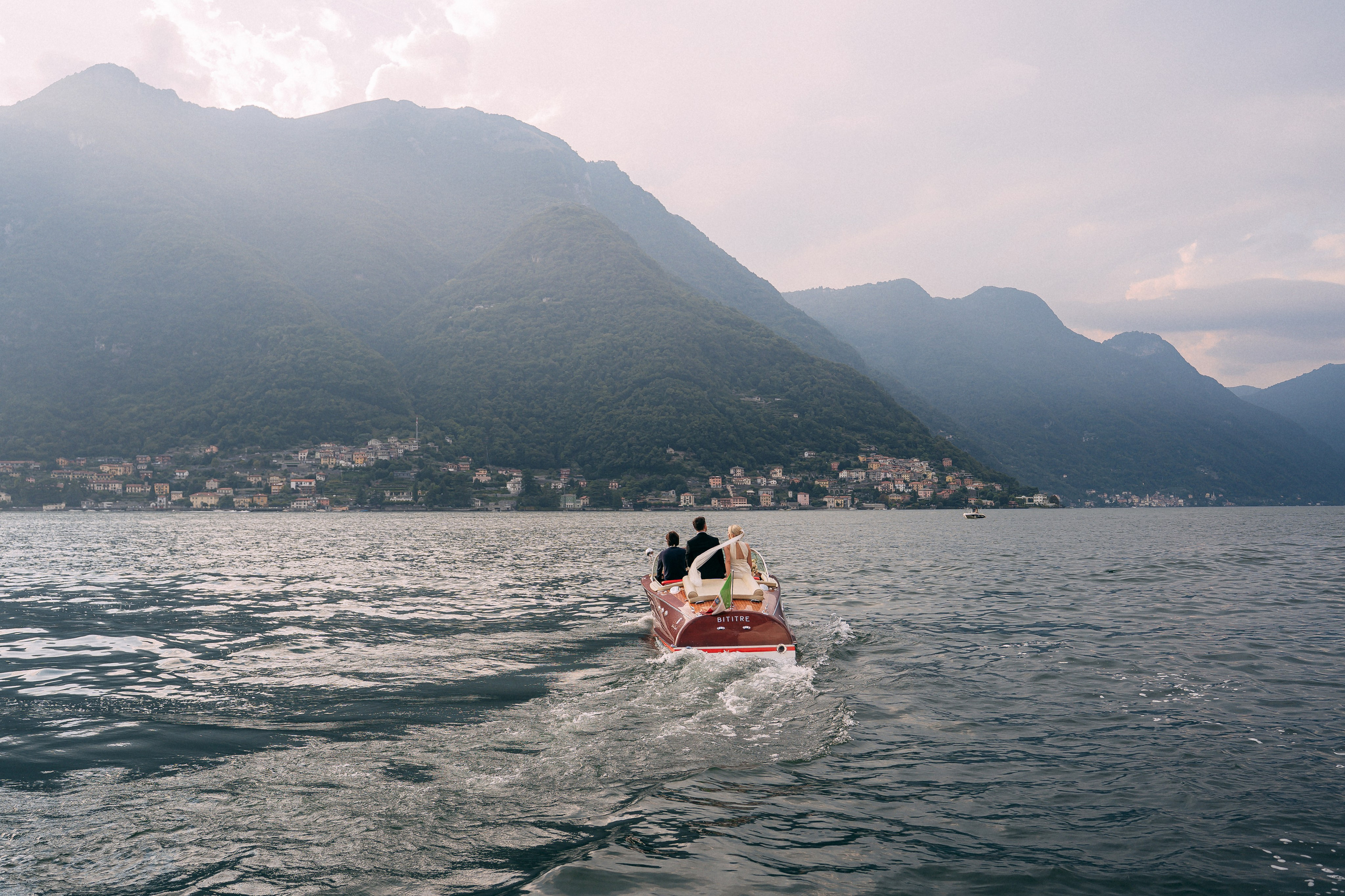 Boat crossing Lake Como with mountain views at Villa Lario, Italy