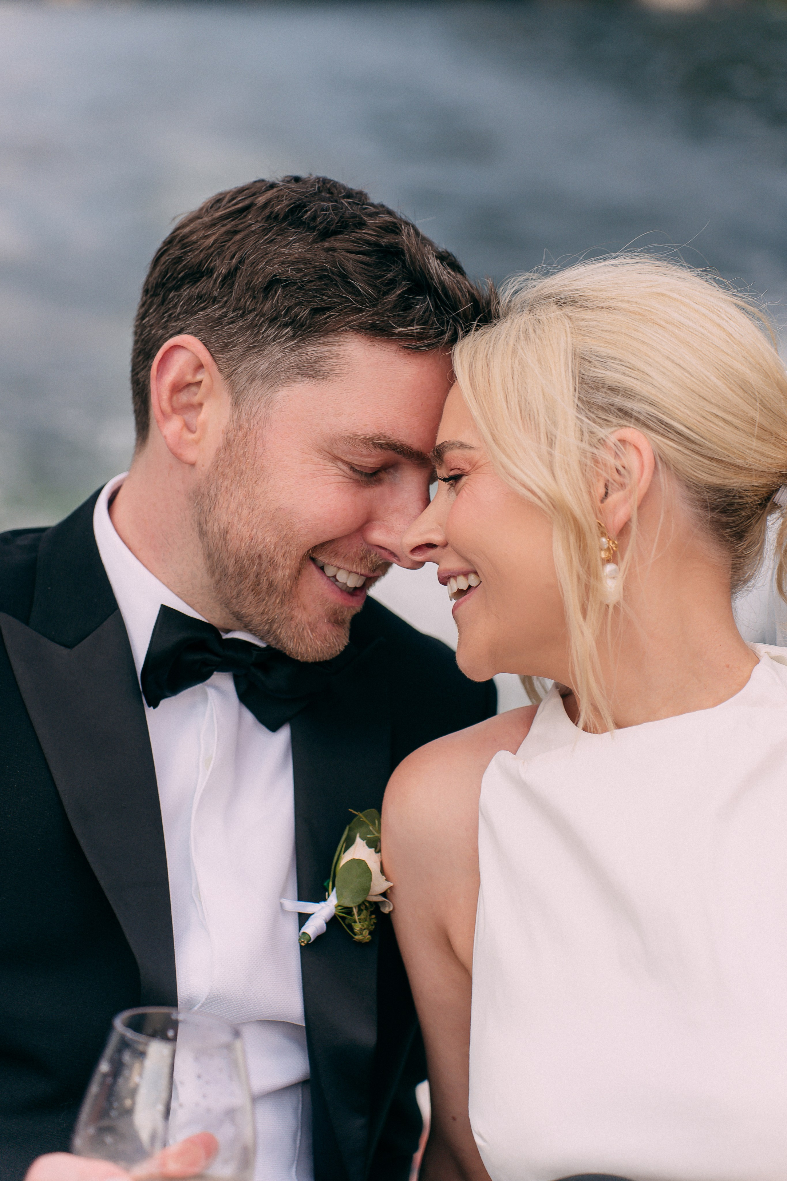 Bride and groom sharing a tender moment on the boat at Villa Lario, Lake Como, Italy