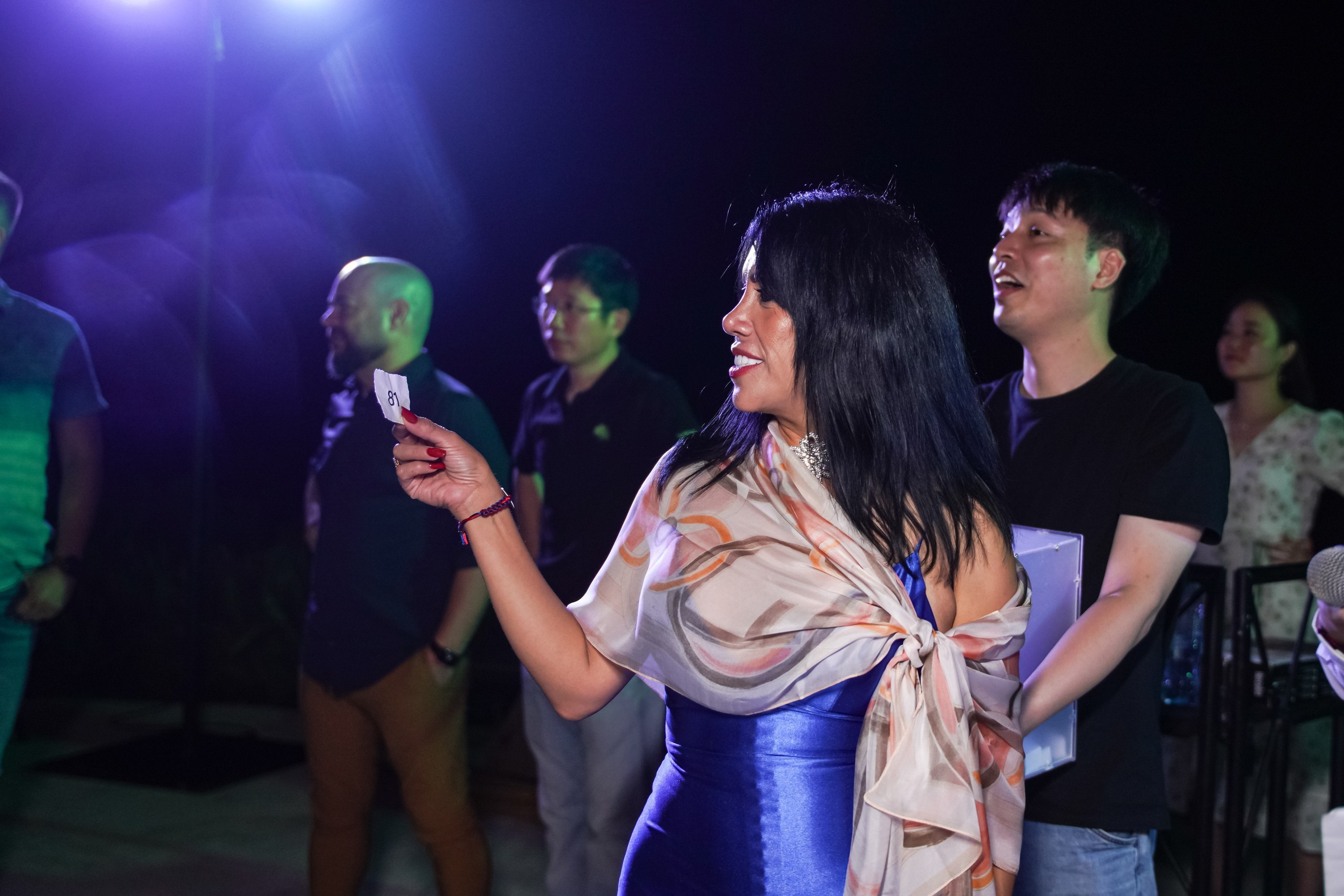 Honoree holding branded gift box at ceremony.