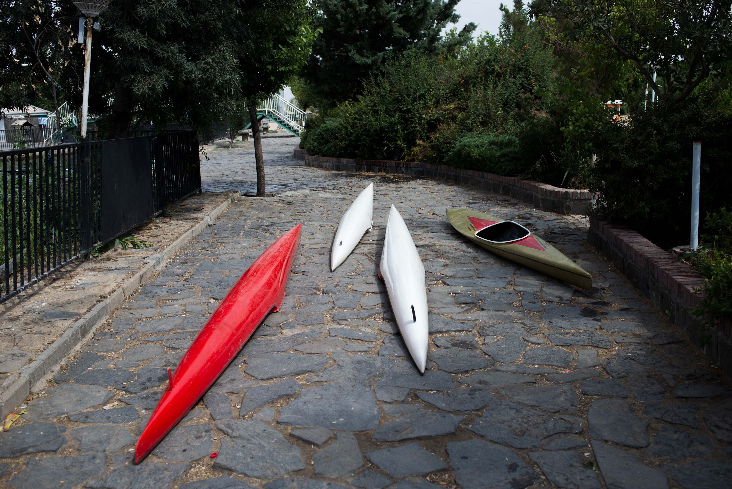 Team members pull their kayaks out of the water during a break in training.