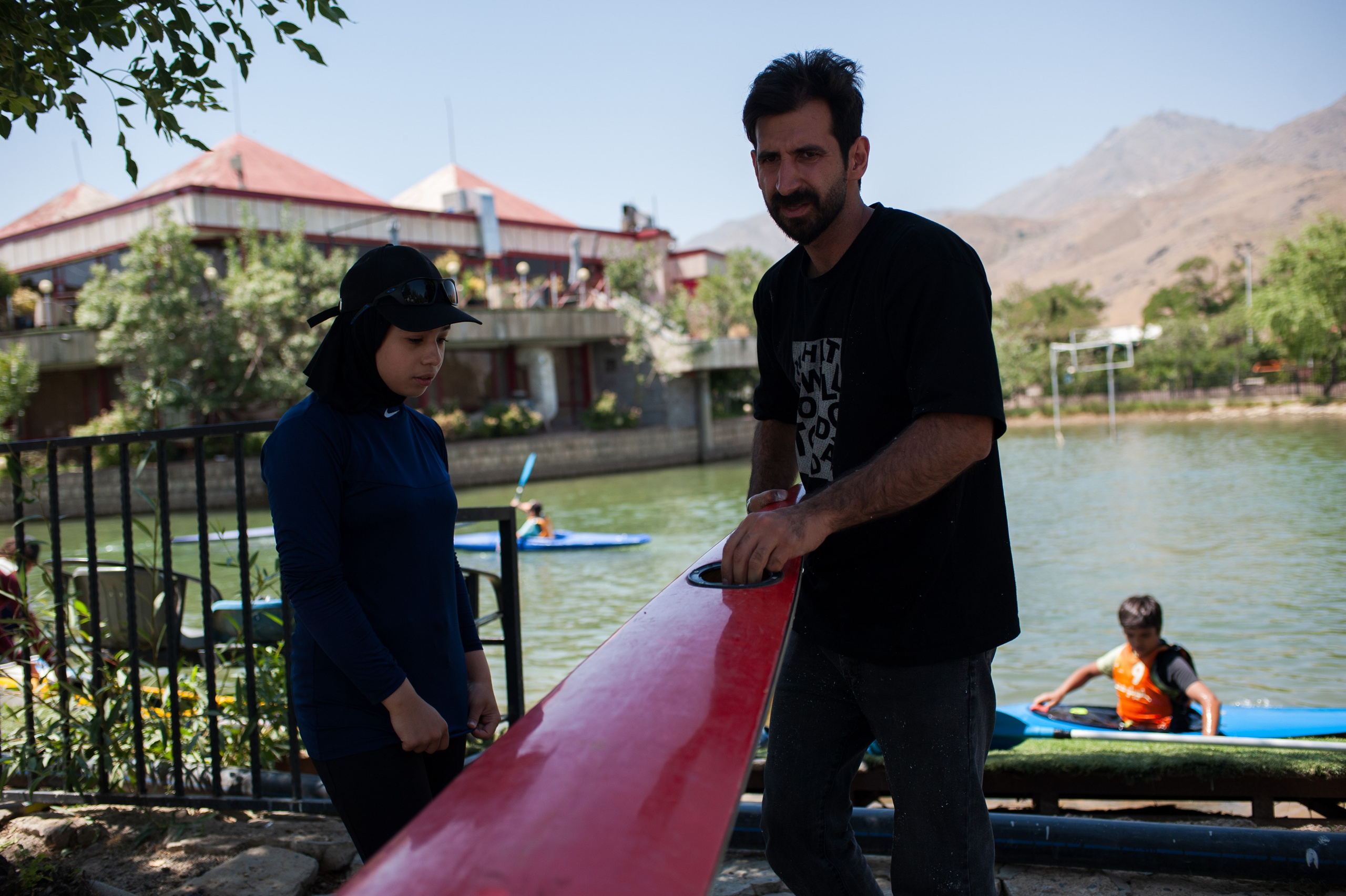 Coach Mohammad Valadi carries out part of the team’s kayak repairs and maintenance on his own.