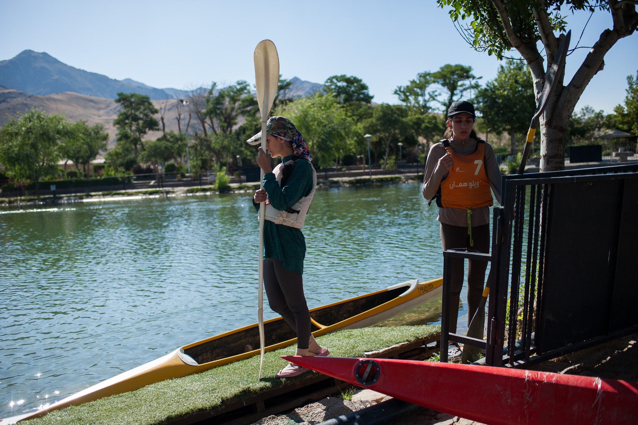 Romina and Yeganeh, members of the team, prepare to enter the pool for training.