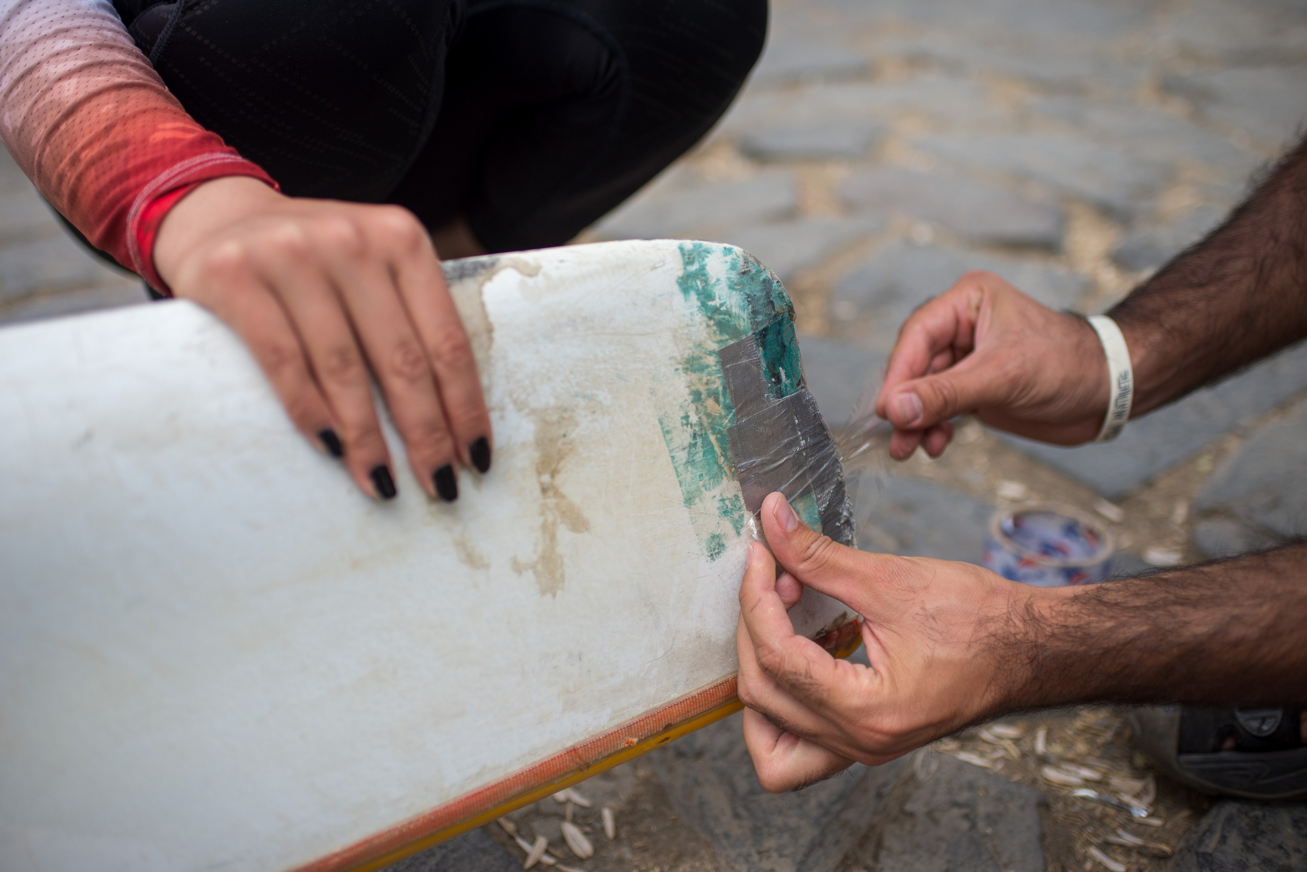 Mohammad Valadi repairs and prepares one of the team’s kayaks.