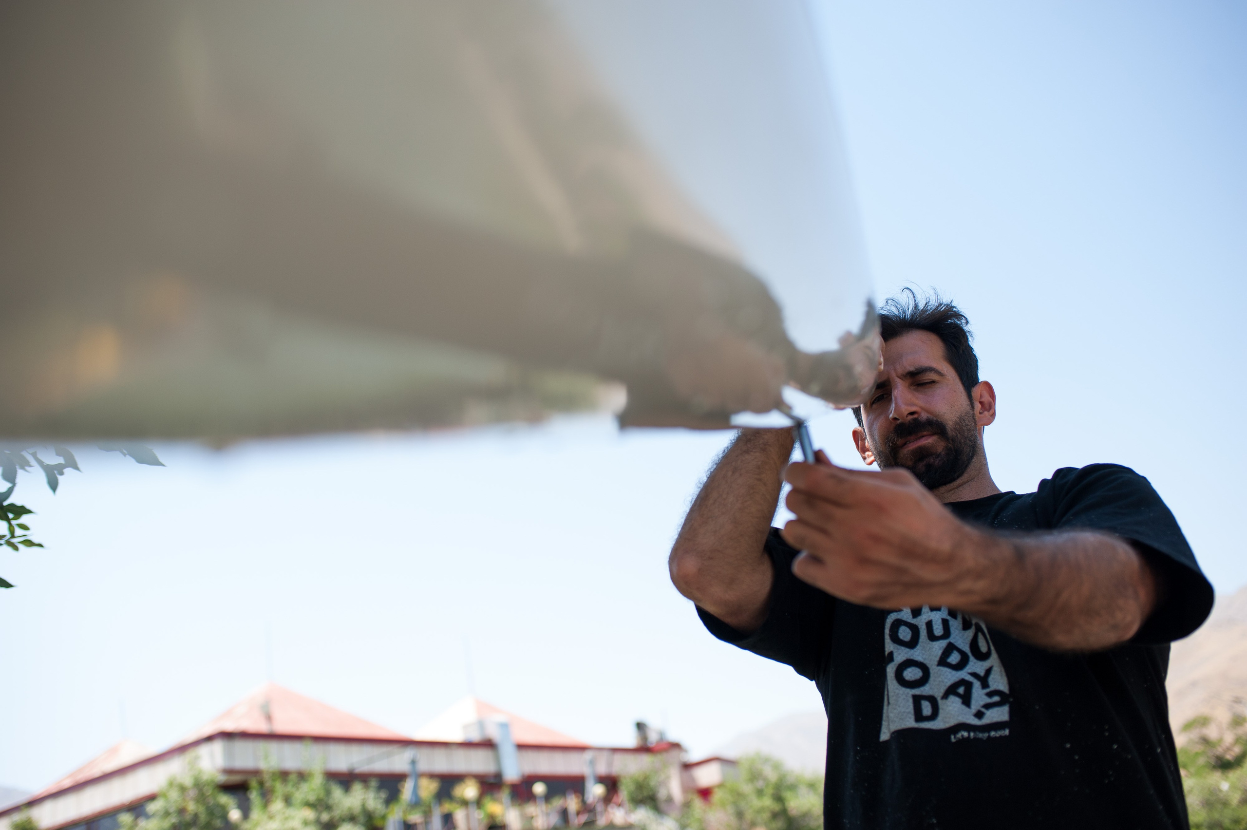 Mohammad Valadi adjusts the rudder of one of the team’s kayaks.