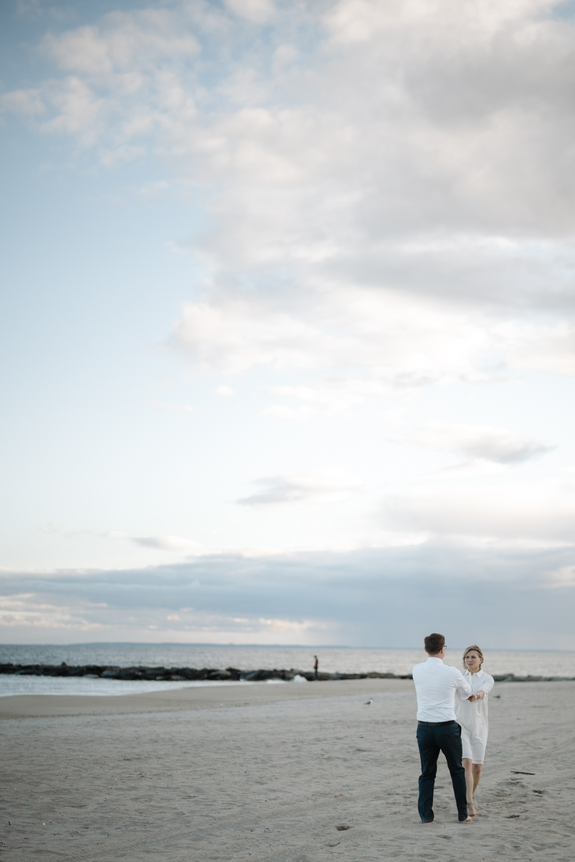 Candid photos of a couple on the beach. Portrait and wedding photographer in New York