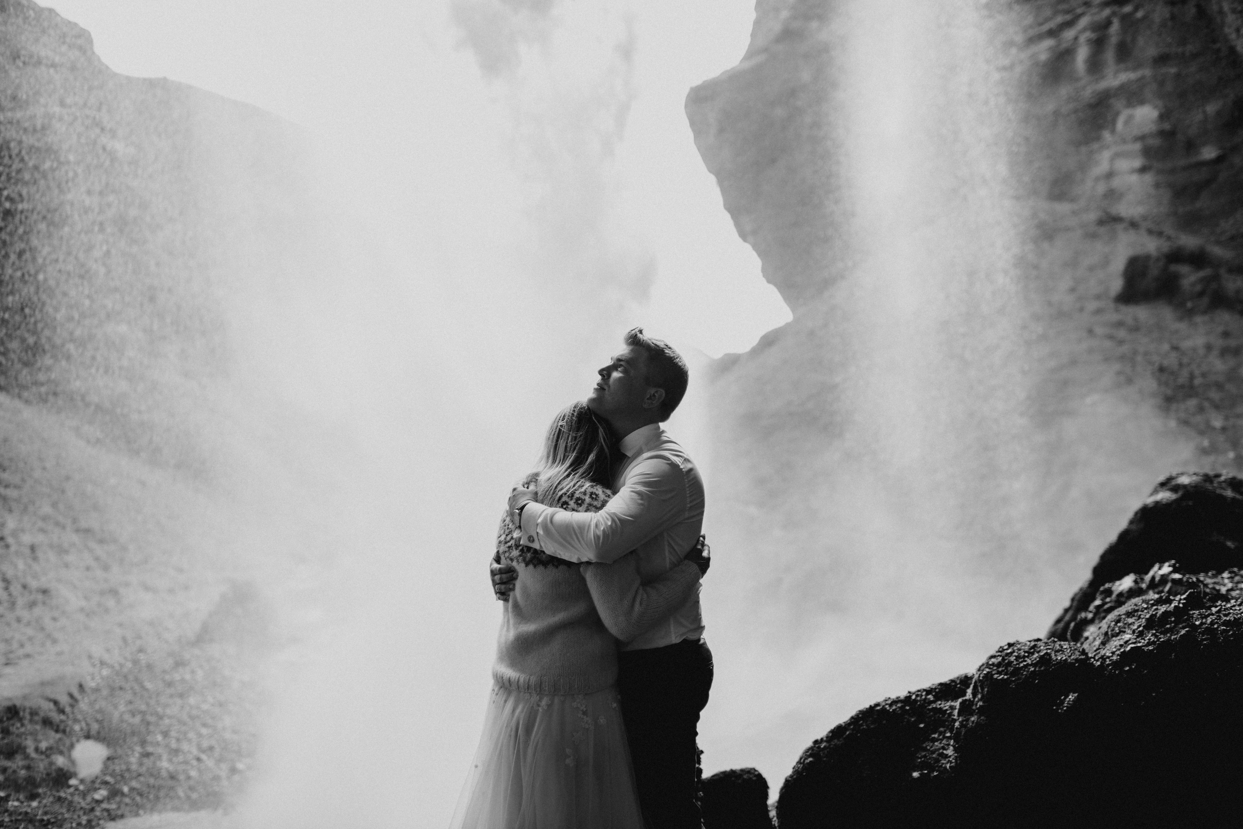 Eloping couple exploring the lush green canyon near Kvernufoss, surrounded by untouched Icelandic nature.