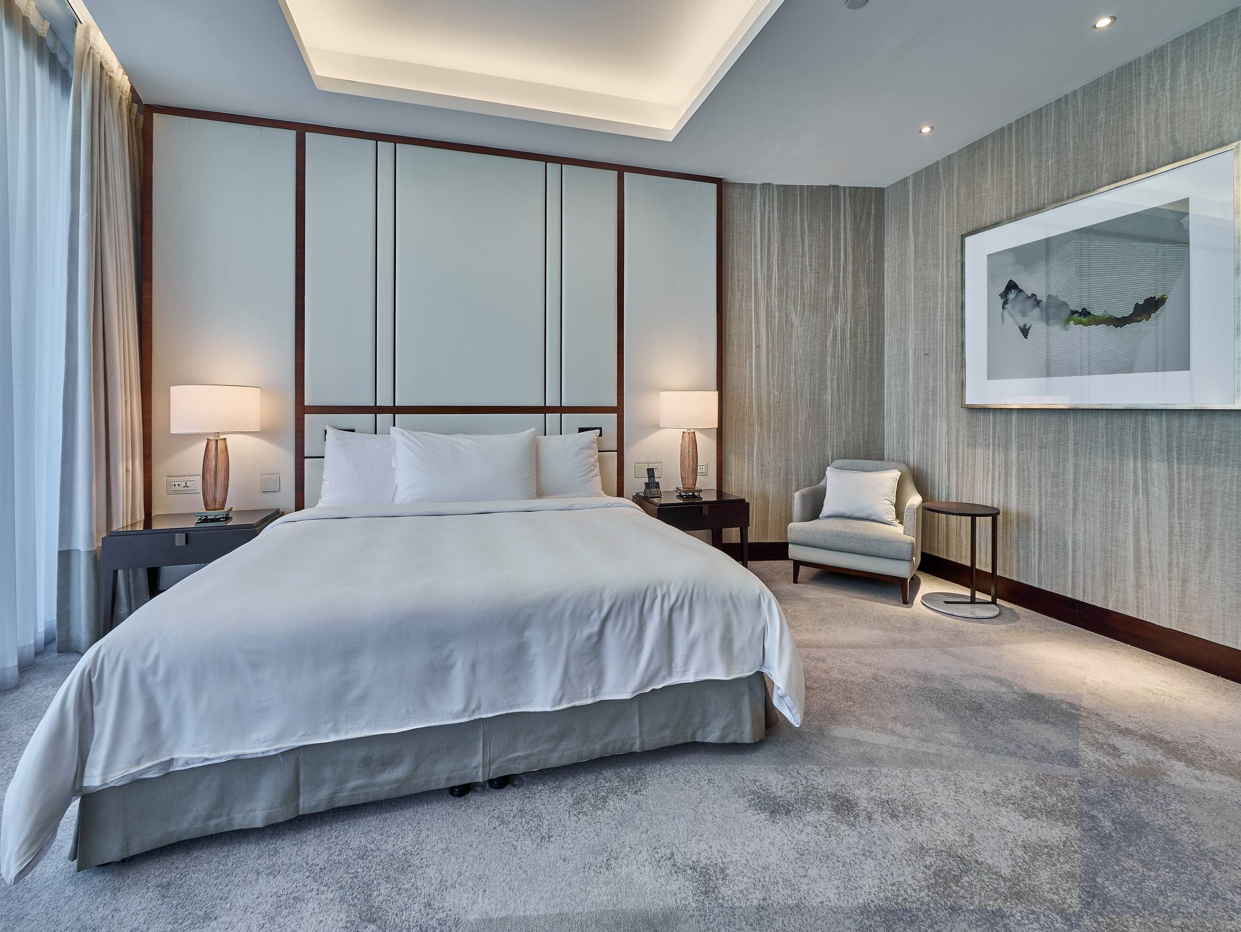 Wide-angle interior shot of a premium bedroom with neutral tones, perfect for showcasing property comfort and layout on Booking or real estate platforms.