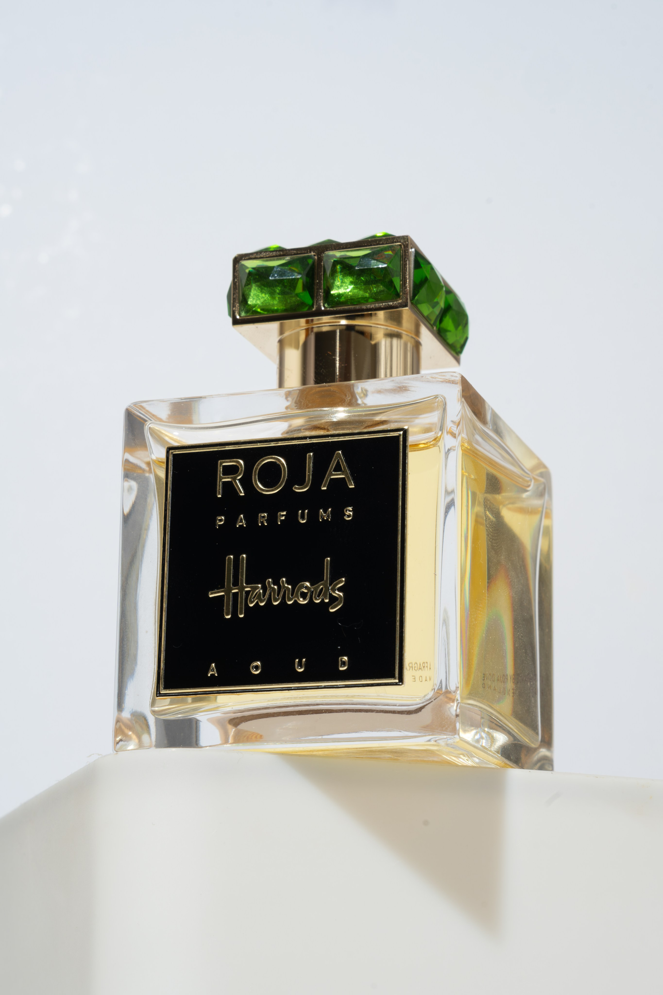 Crystal perfume bottle with emerald cap — modern editorial product photography by Jay Soundo.