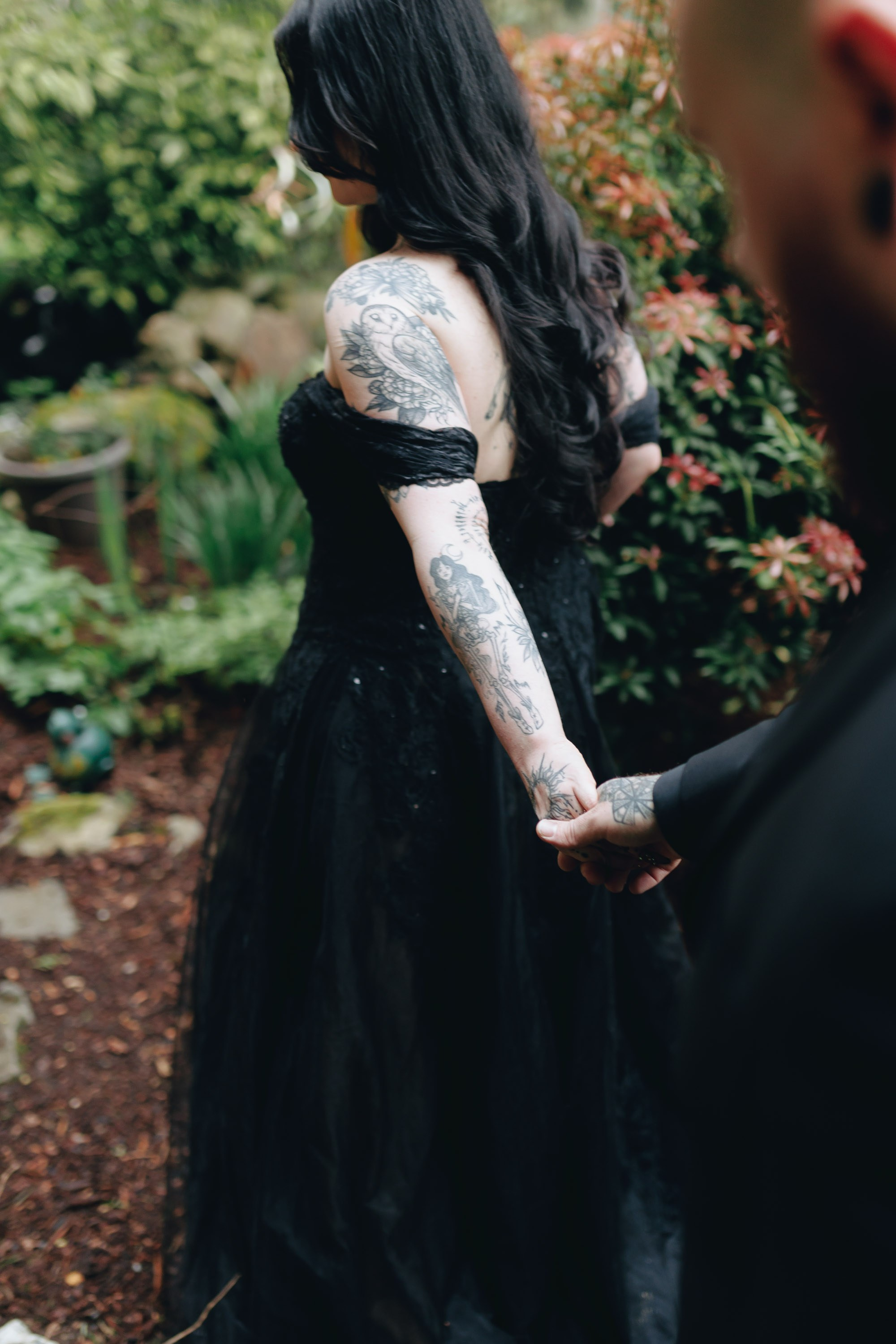 Bride sitting under tree with bouquet, peaceful wedding portrait