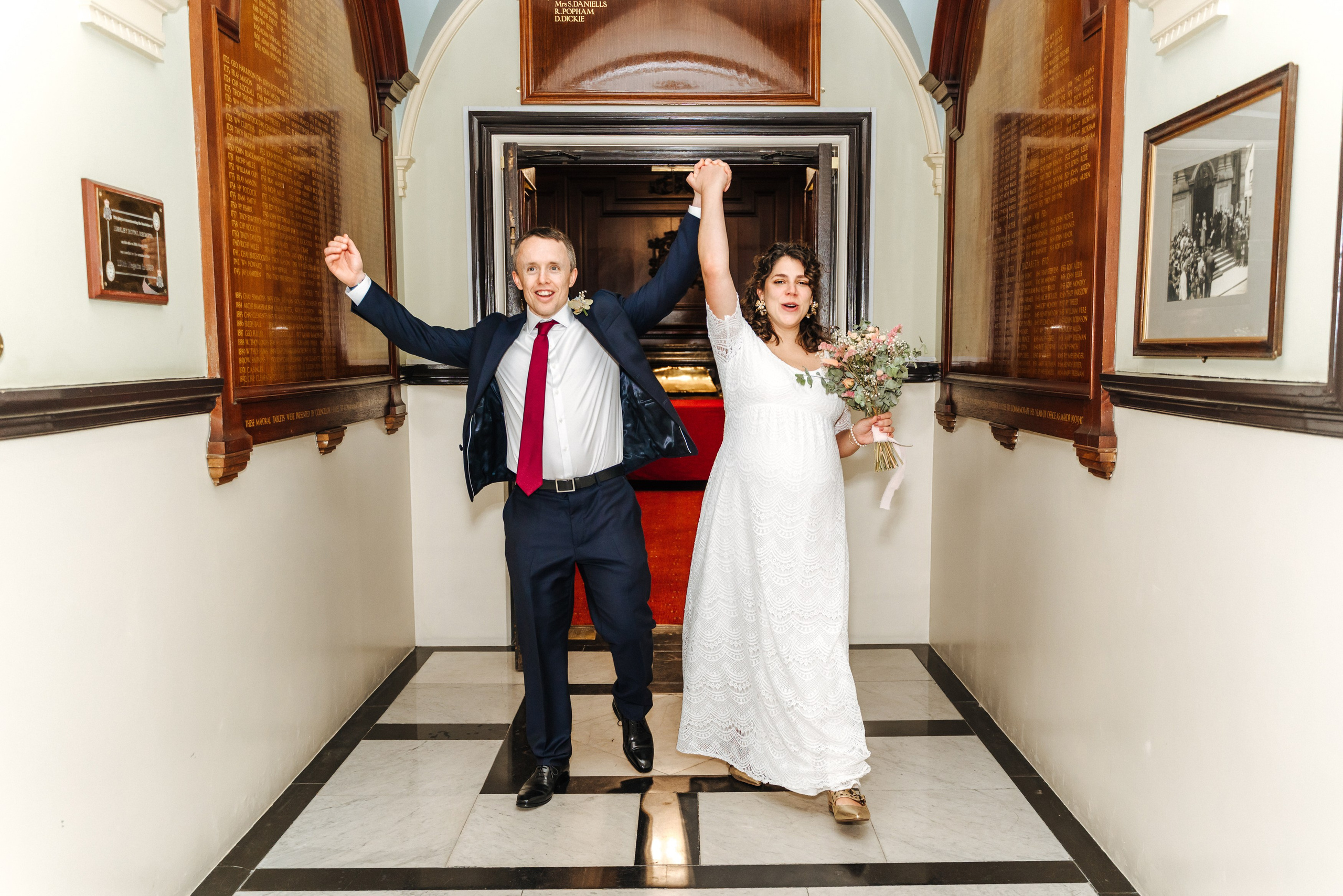 Groom and Bride standing together in the doorway of Henley-on-Thames Town Hall on their wedding day.