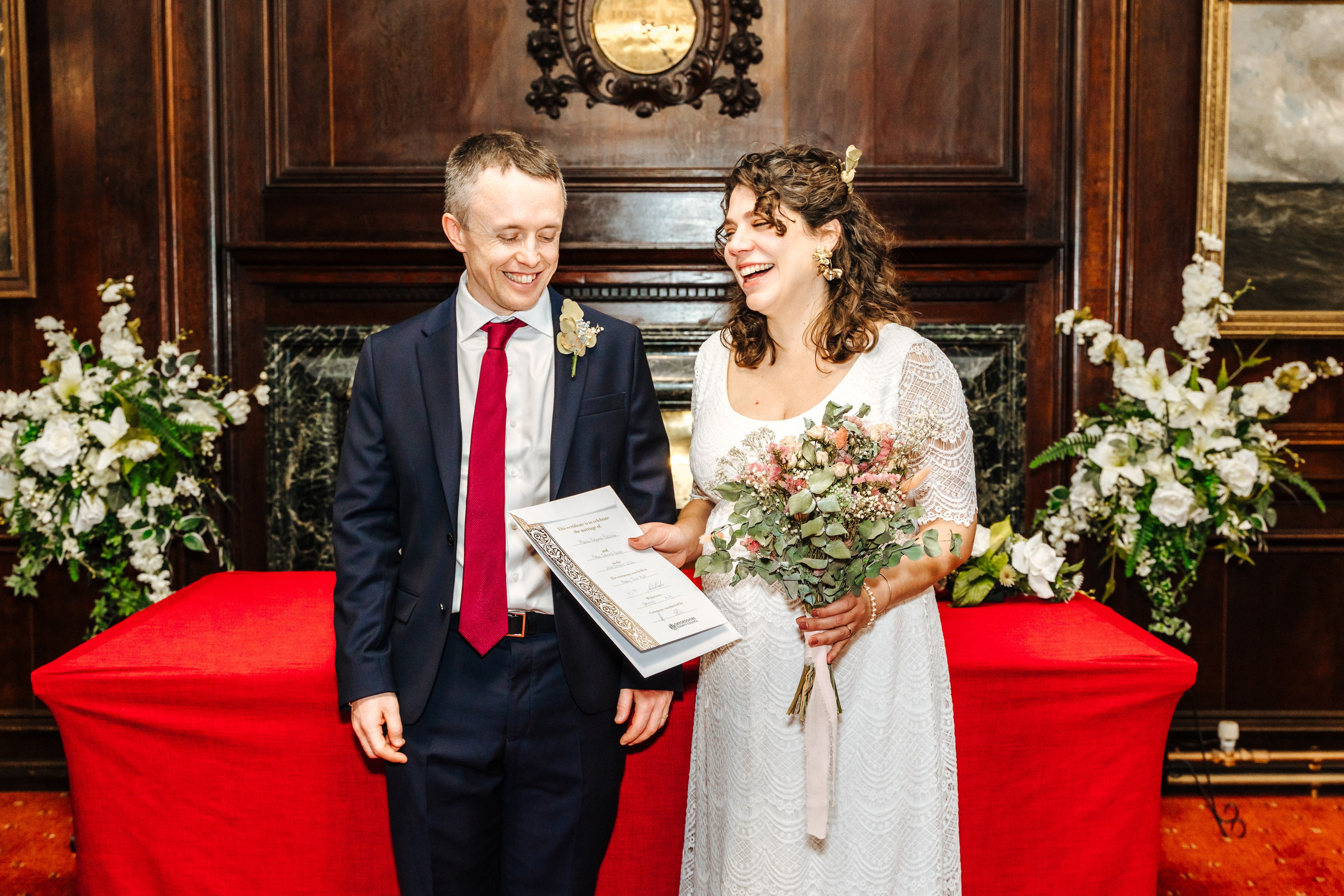 Groom and Bride holding their marriage register after their wedding ceremony in Henley-on-Thames.