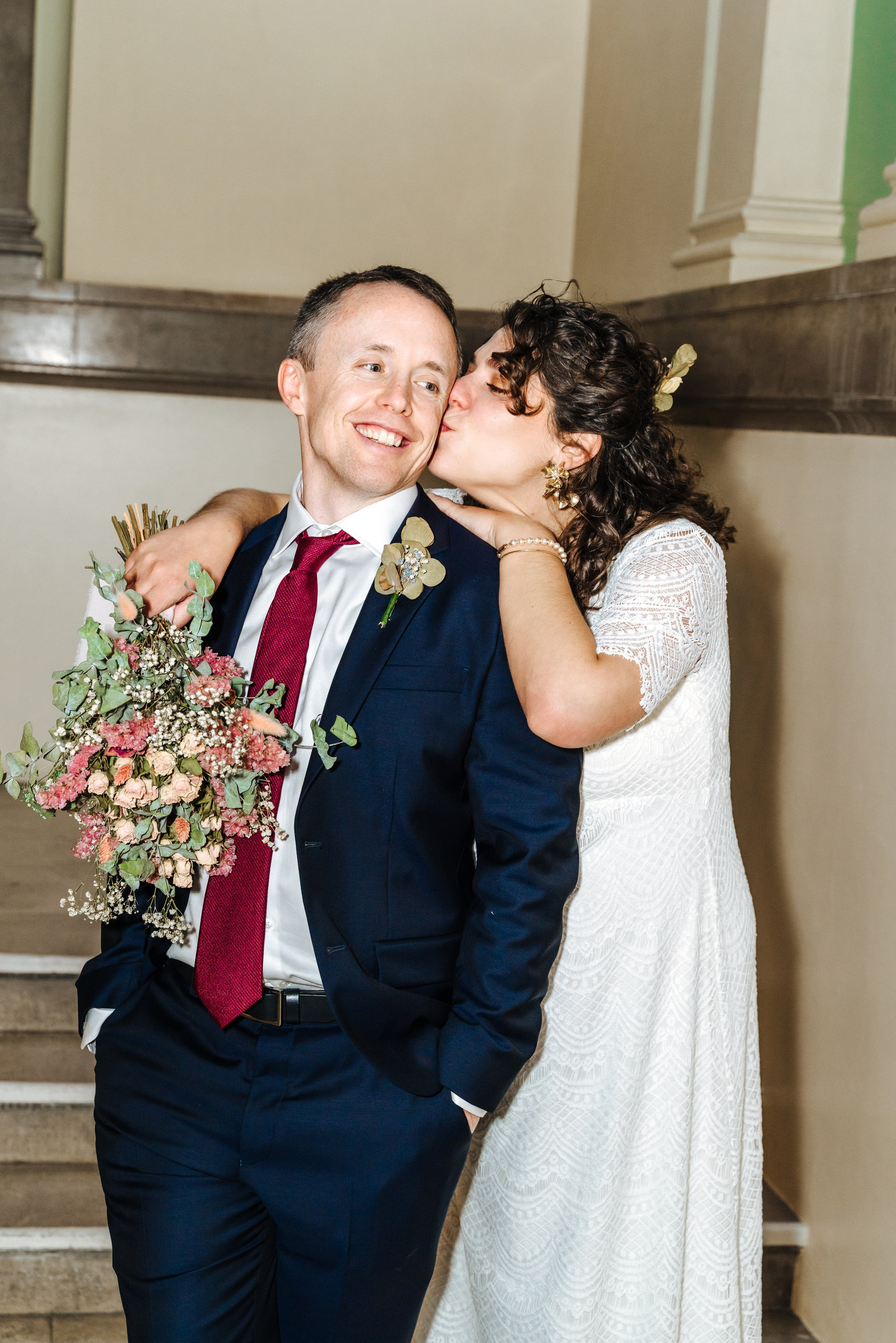 Virginia kissing Peter on the cheek during their relaxed wedding portrait session in Henley-on-Thames.