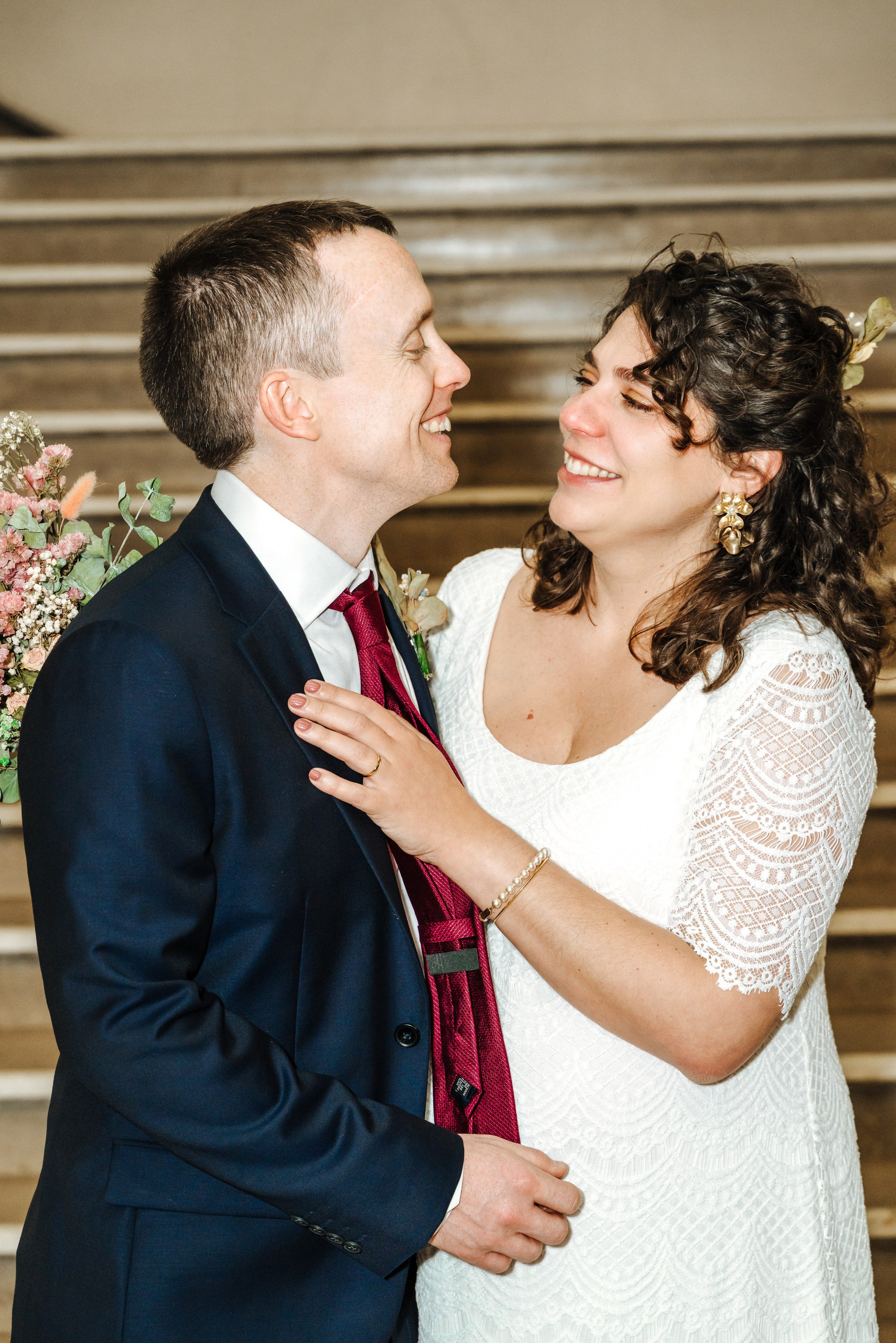 Groom and Bride looking at each other lovingly during their wedding portrait session at Henley-on-Thames Town Hall.