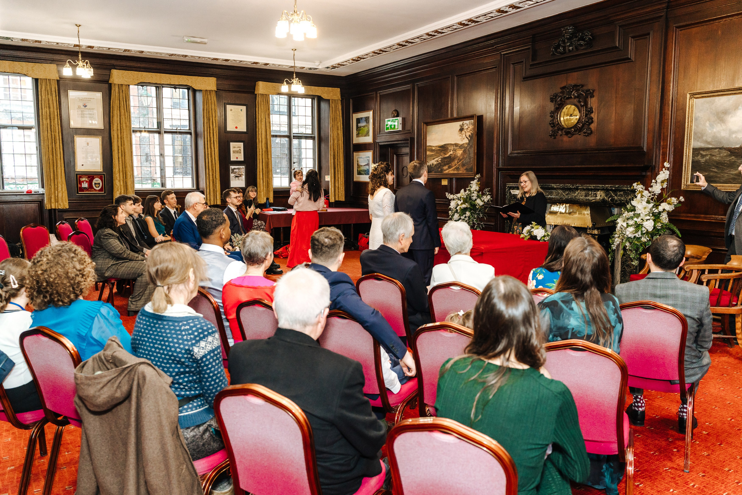 Family and friends watching Peter and Virginia's intimate civil wedding ceremony in Henley-on-Thames.