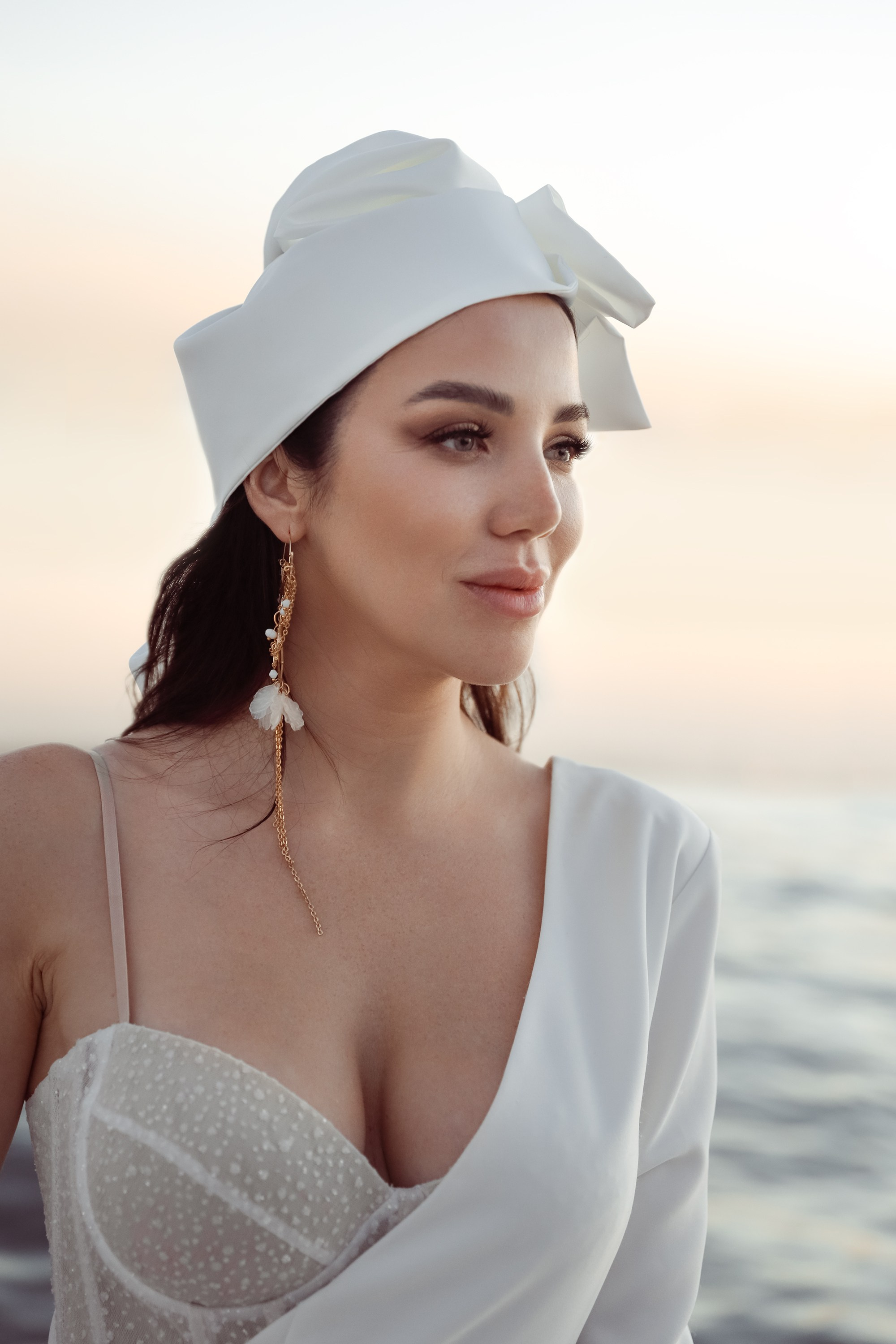 A woman smiles softly on a yacht, her portrait capturing her natural beauty and the tranquility of the ocean surrounding her. Dubai, United Arab Emirates