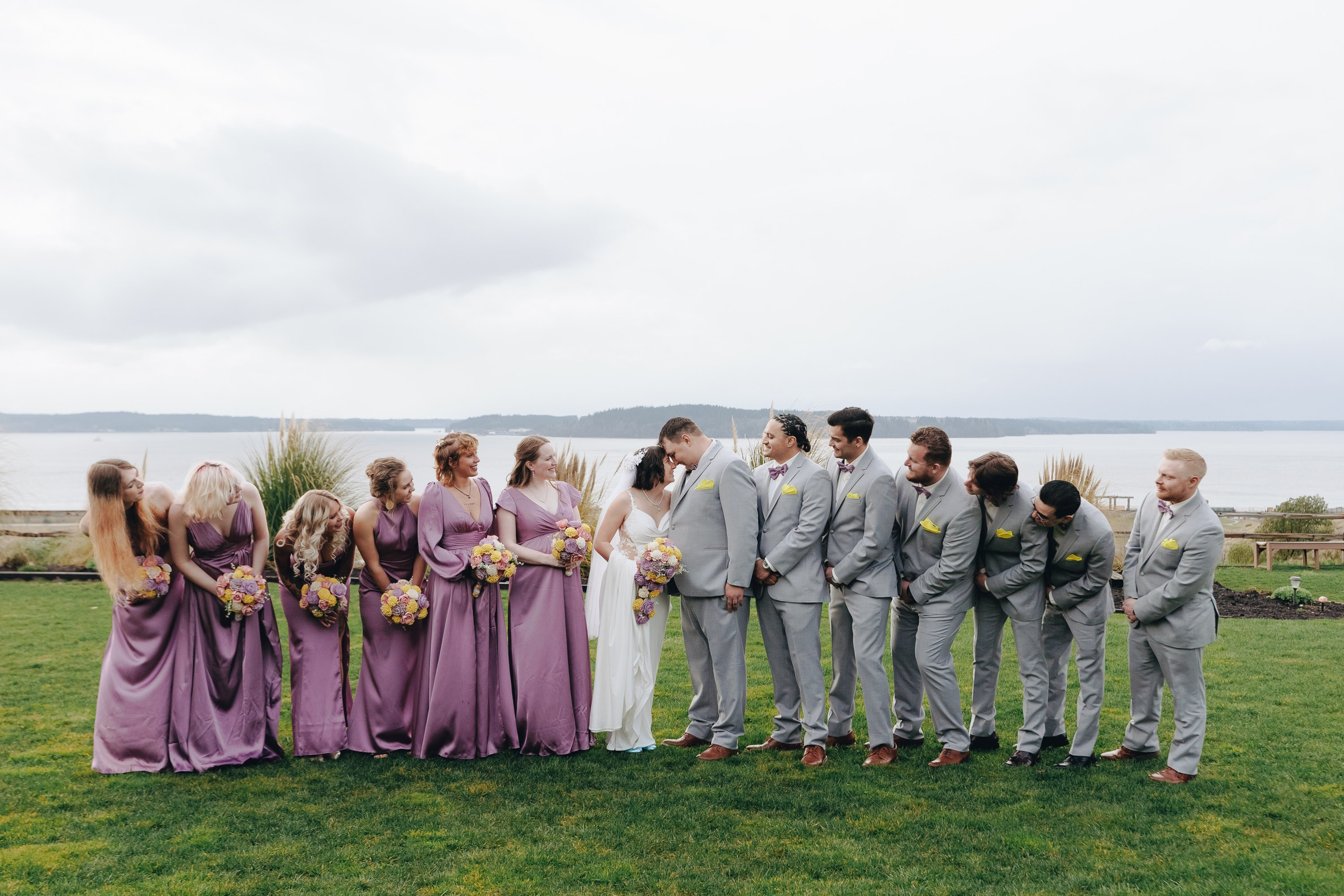 Wedding party posing in field, group portrait