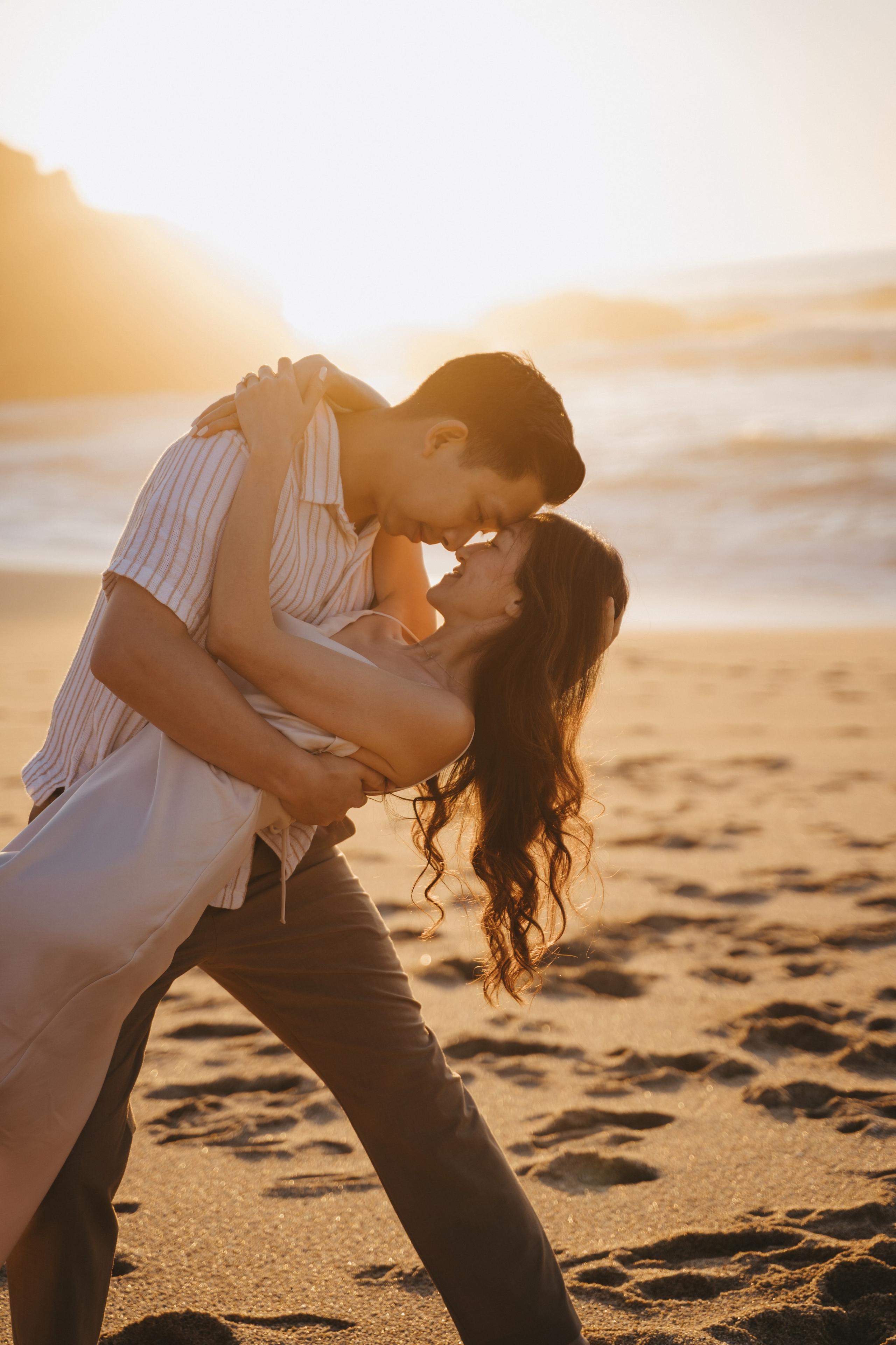 A photo shoot on the San Francisco beach at sunset. Engagement session. 