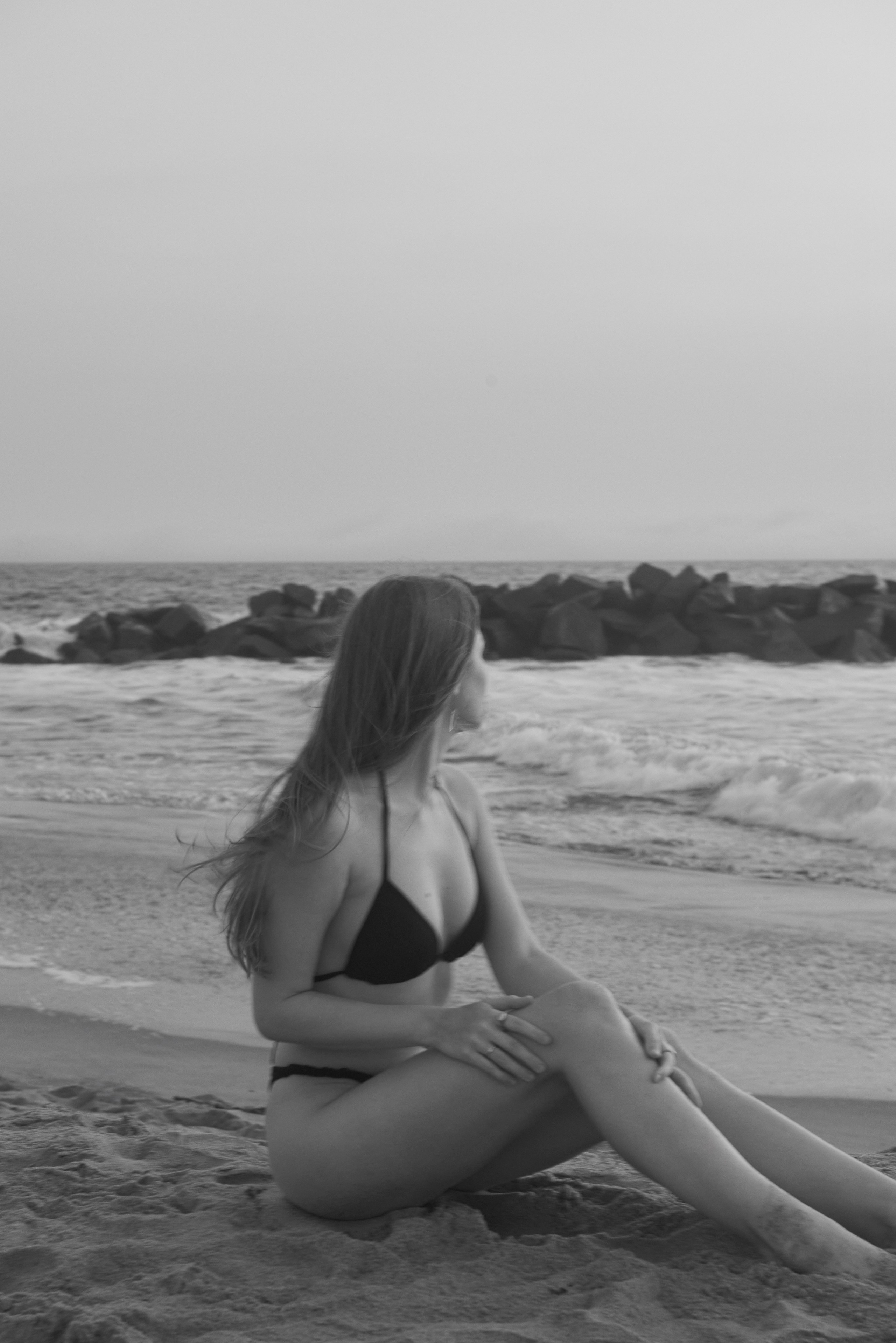 Girl dreamily gazing at the ocean in the golden light