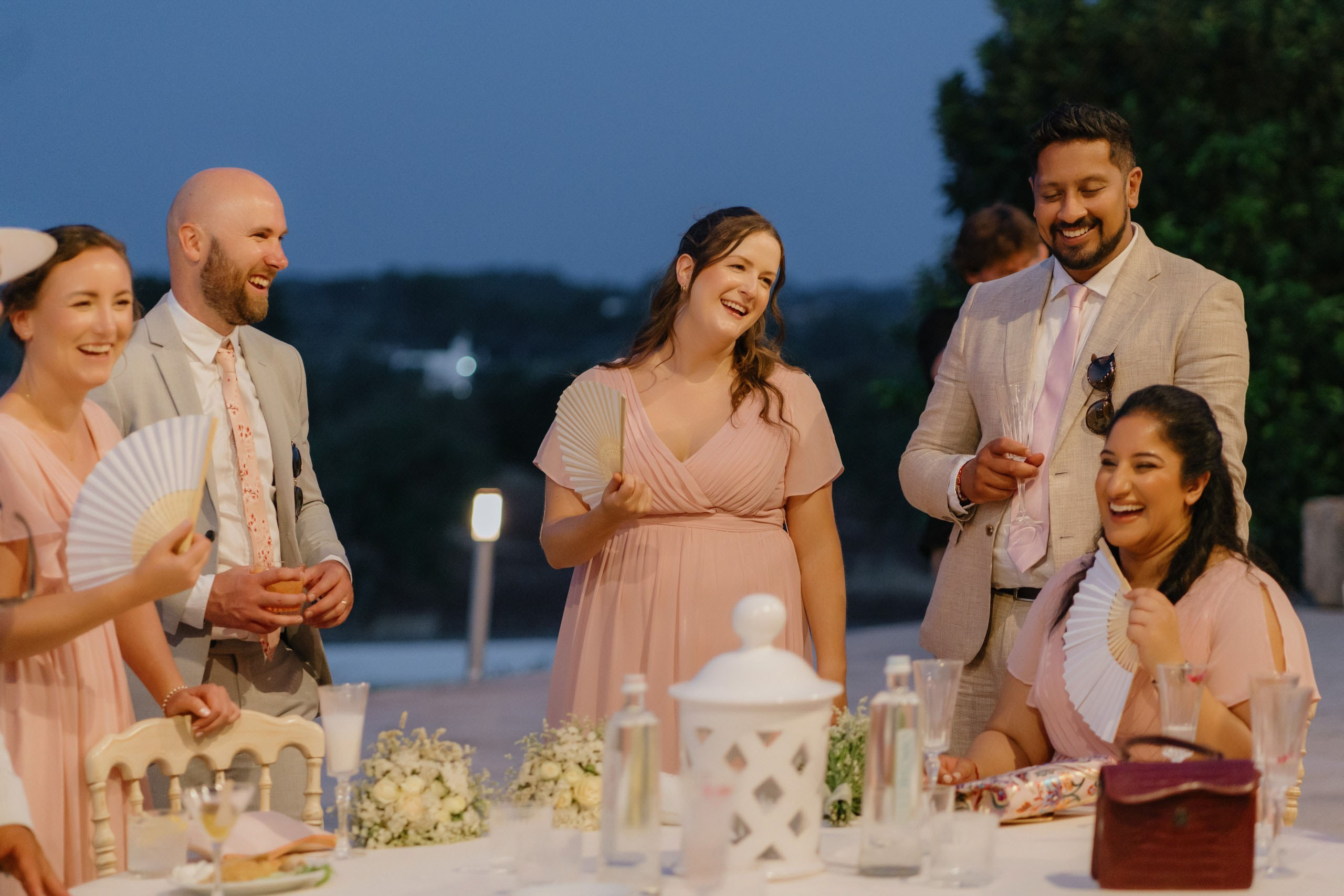Guests enjoying dinner under arches at Masseria Traetta, elegant destination wedding atmosphere in Italy