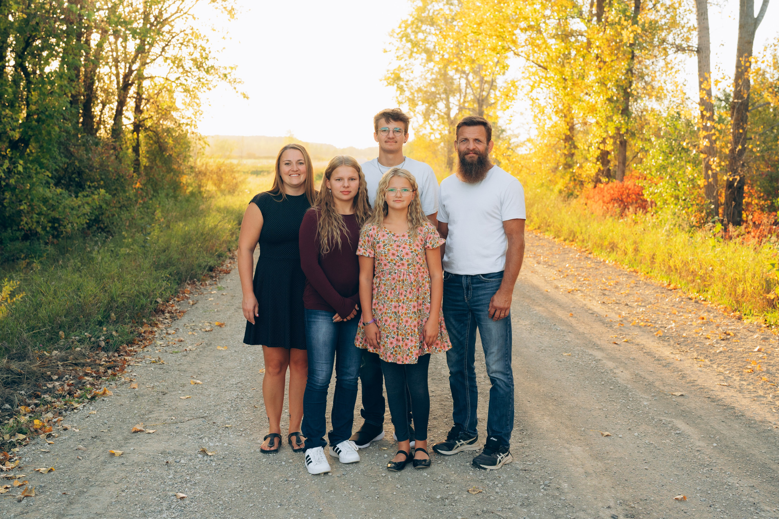 Parents cuddling with kids in a park