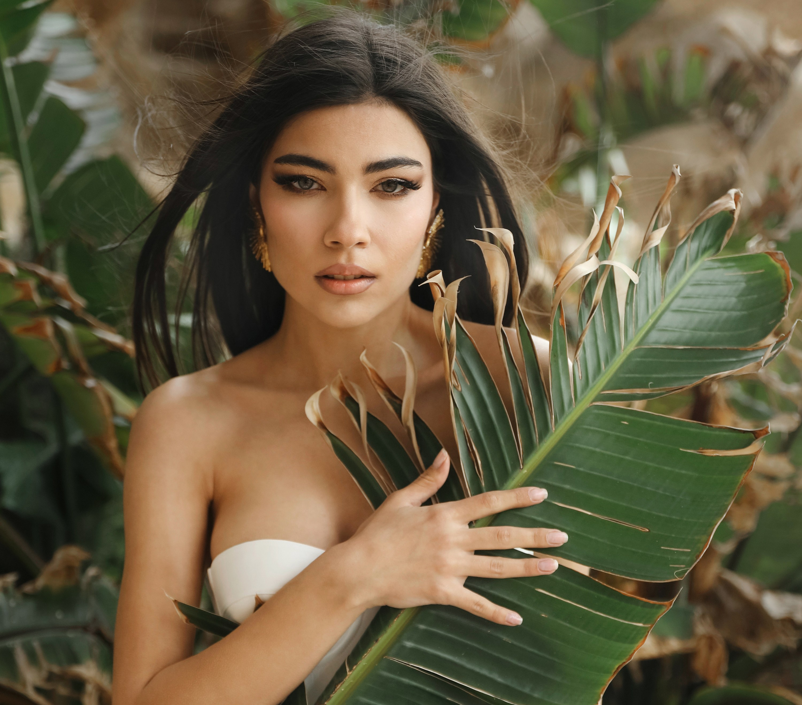 An art photo shoot of a girl in a wedding dress on the windy Kalithea beach in Rhodes, Greece