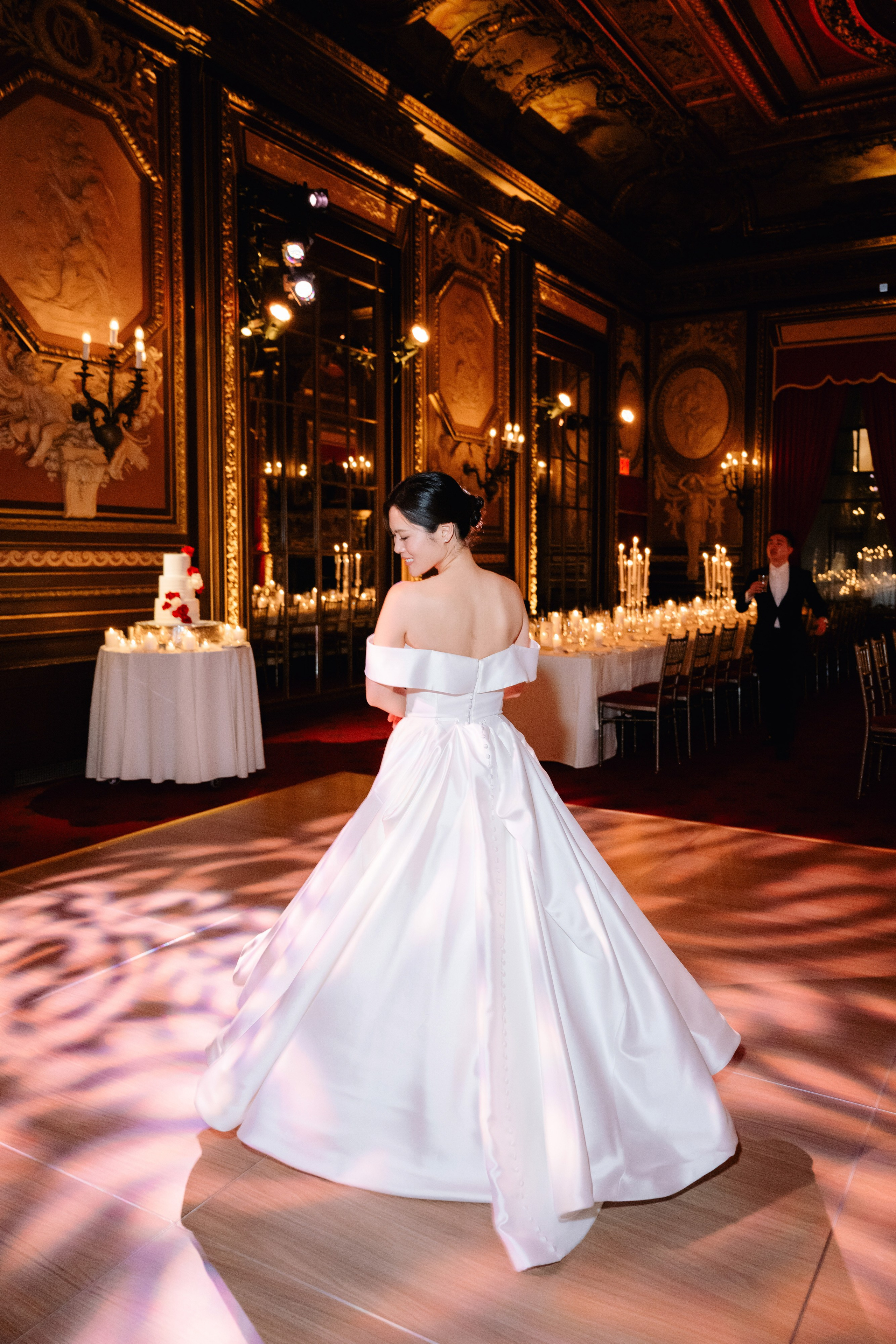 a woman in a white dress is standing on a dance floor