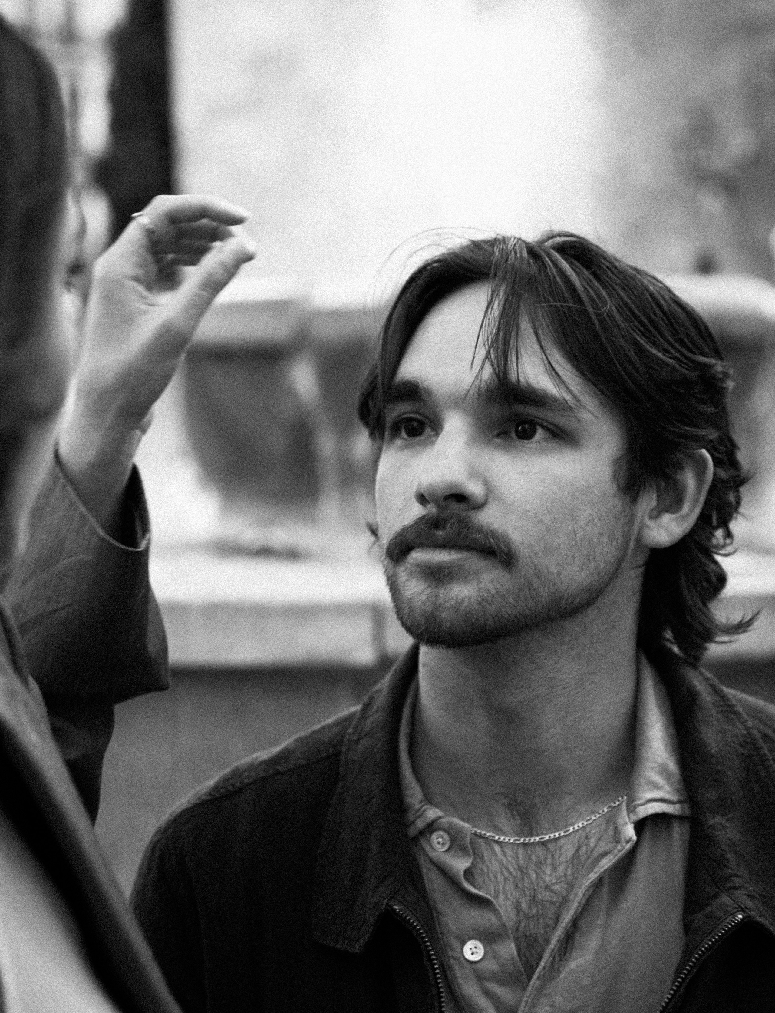 Black-and-white close-up of a young man gazing lovingly at his partner during a romantic couple photoshoot in Benidorm, Spain — perfect for those seeking natural, emotional love story photography in Benidorm and throughout Spain.
