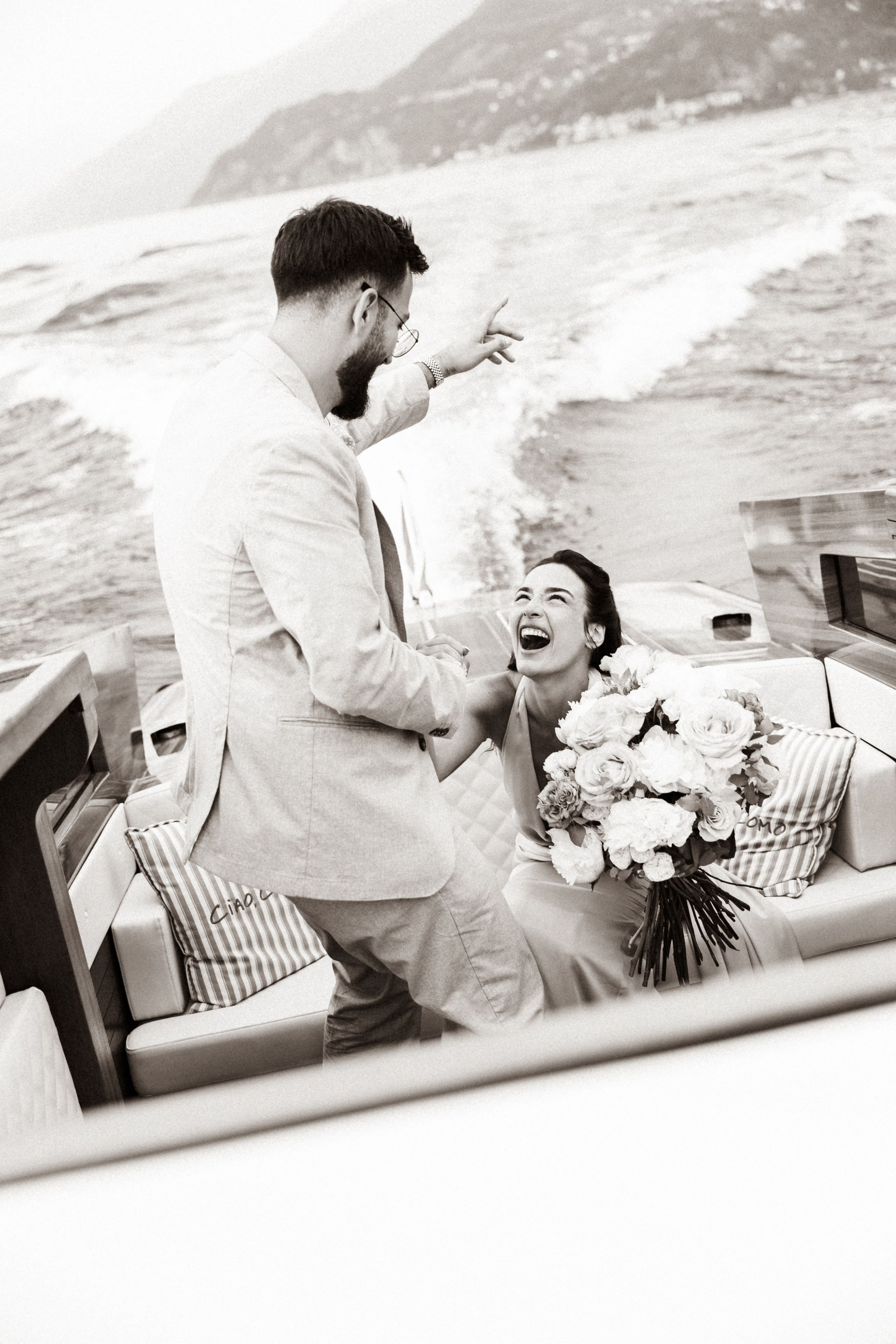 Joyful couple celebrating their engagement against the backdrop of Lake Como