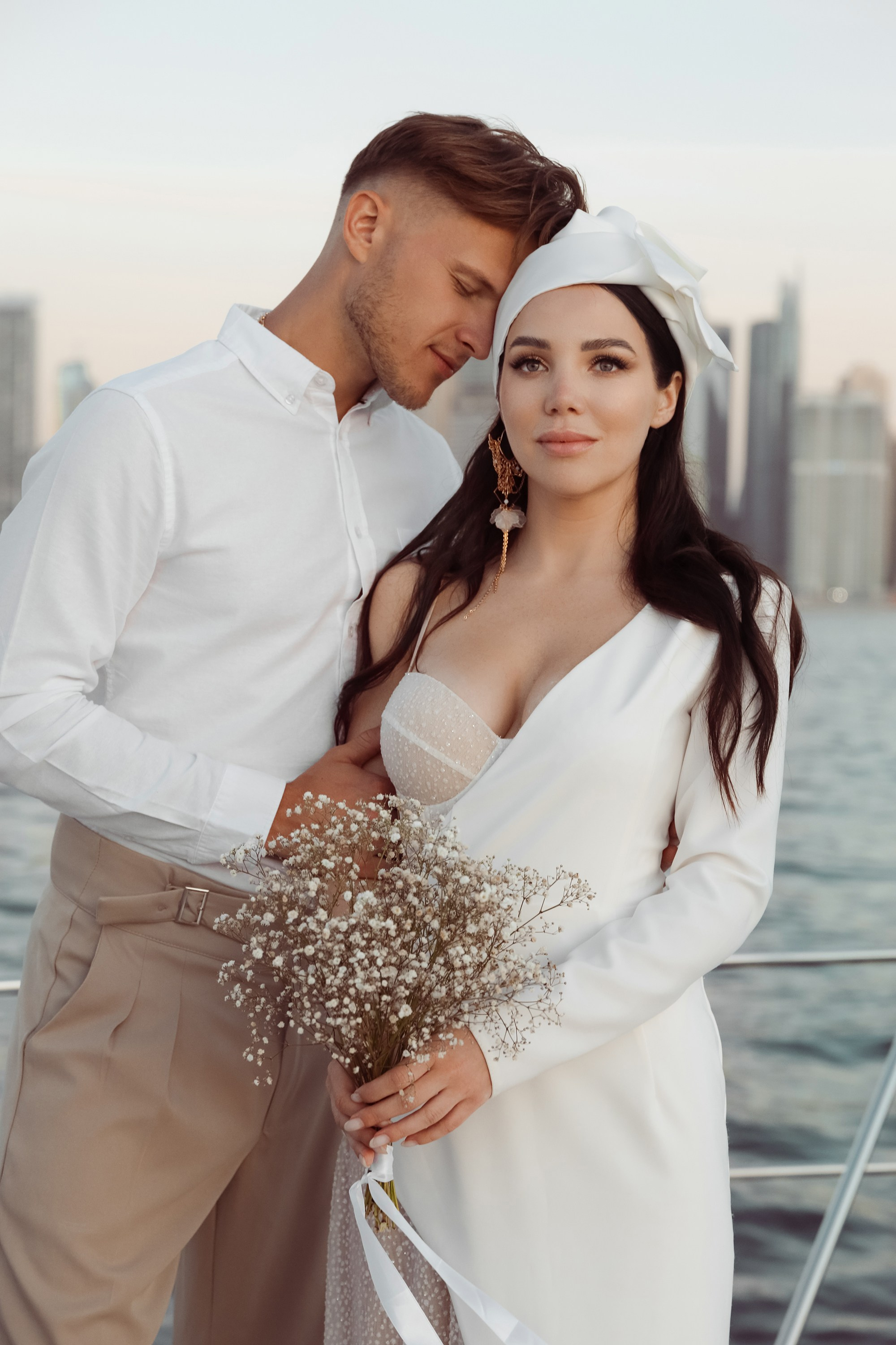 A couple’s love story told through portraits on a yacht: together, they share an embrace. Dubai, United Arab Emirates