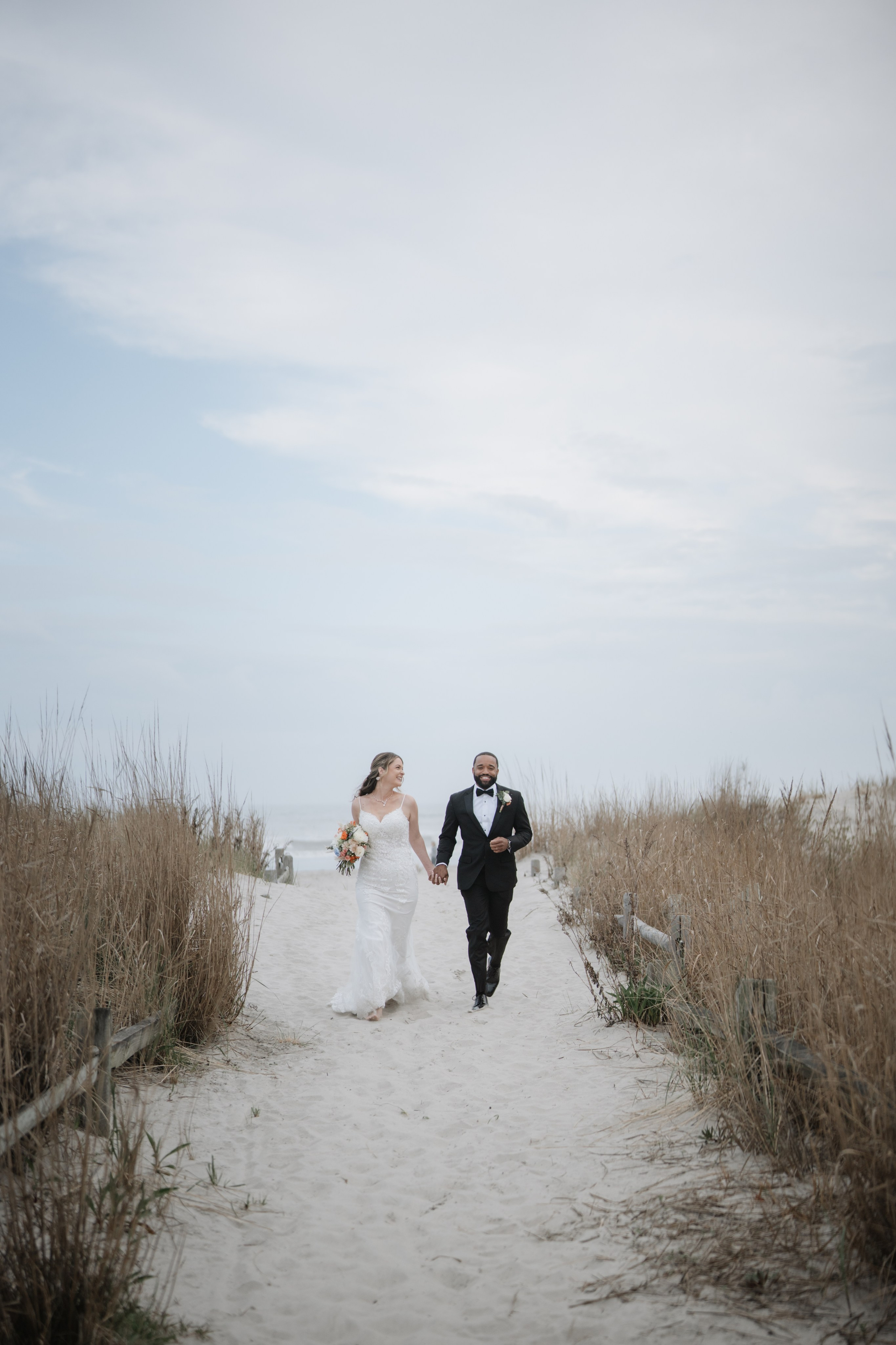 Wedding walk on the beach. Portrait and wedding photographer in New York