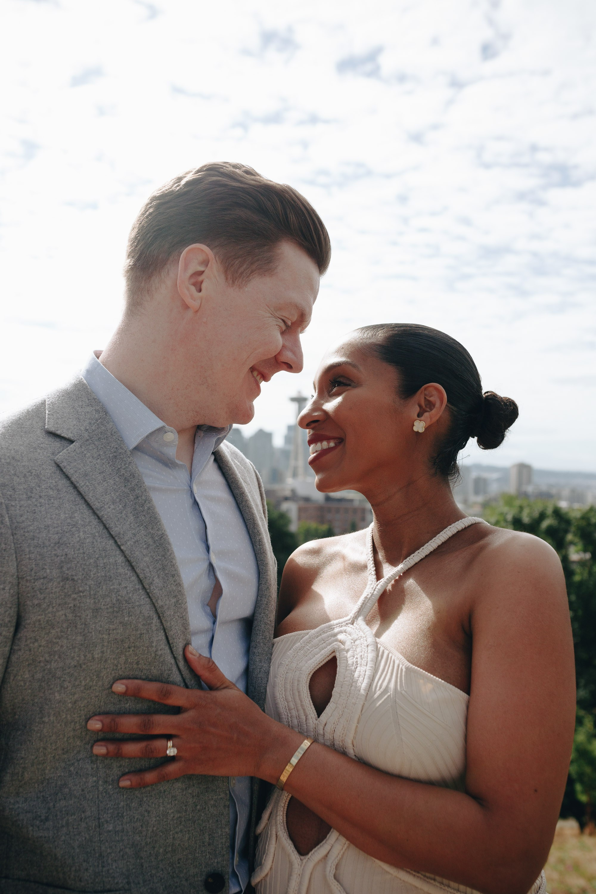 Bride and groom holding hands, smiling at each other