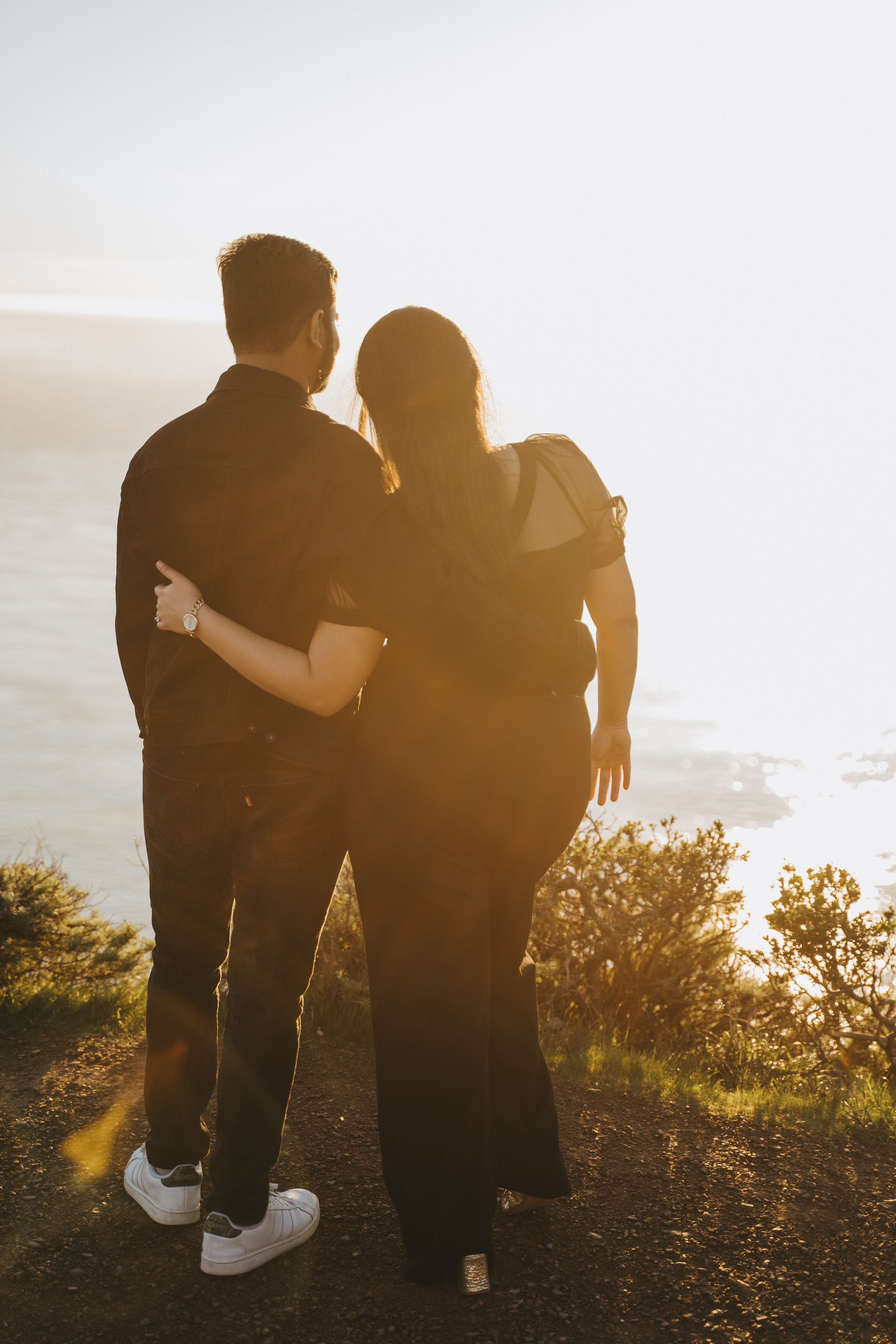 Proposal.  Overlooking the golden San Franisco Bridge sunset with a couple. Photographer Video. 