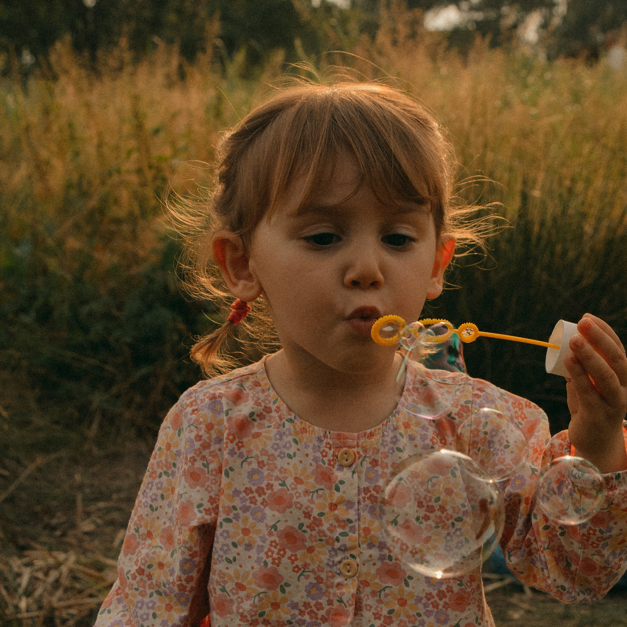 Blowing Bubble. Amazing little girl. Family moment.