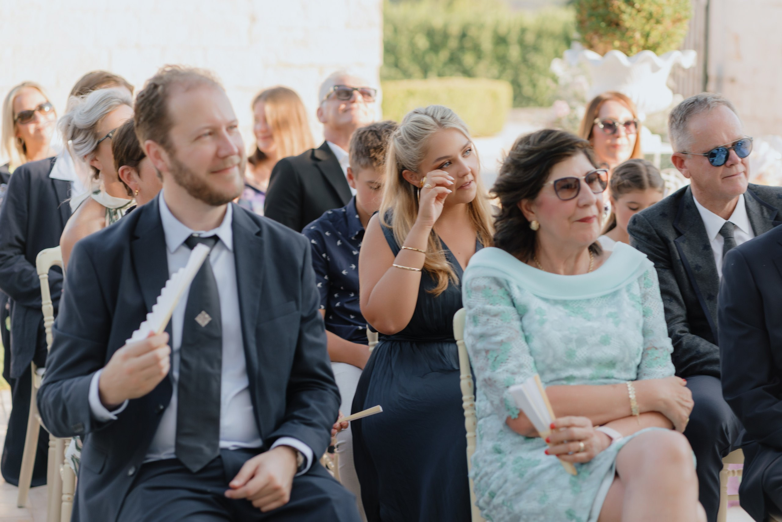 Wedding guests emotional reactions during ceremony, natural and candid destination wedding photography in Ostuni Italy