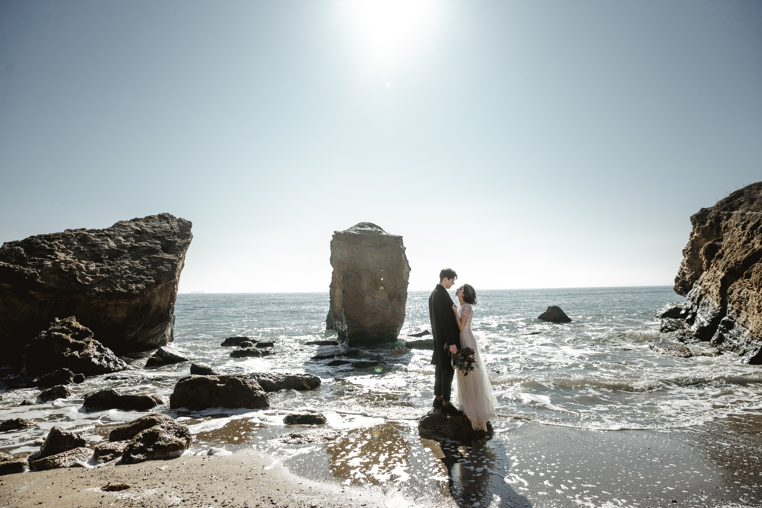 Seaside bridal session with elegant white gown, wedding photography France