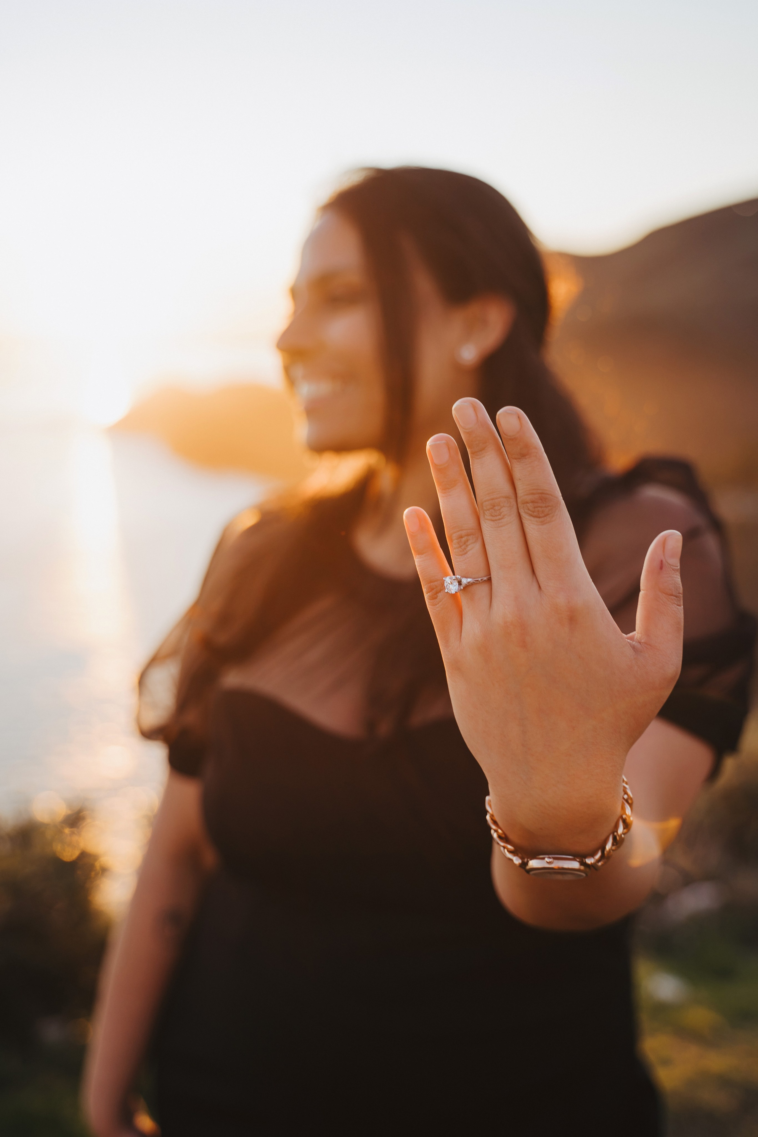 Proposal.  Overlooking the golden San Franisco Bridge sunset with a couple. Photographer Video. 