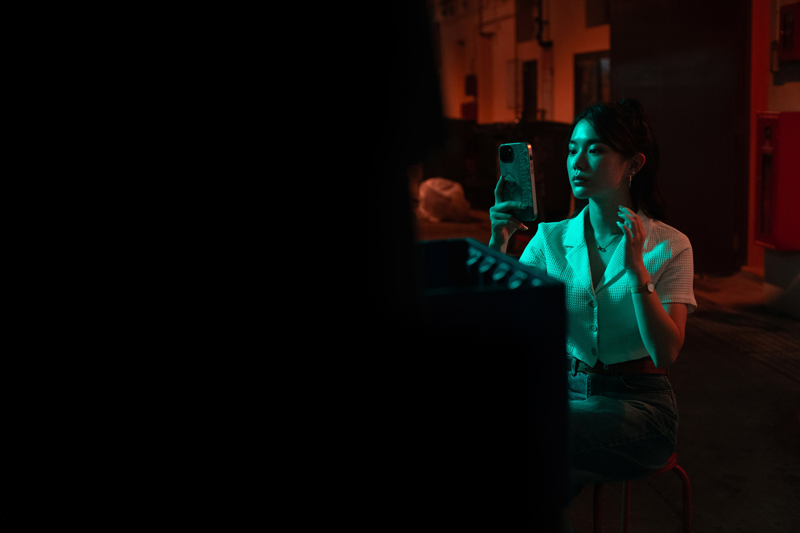 Modern street photography in Singapore capturing an isolated street light against a dark urban background. Shot by a freelance photographer, this editorial image uses artistic lighting to evoke mood and sophistication for branding purposes.