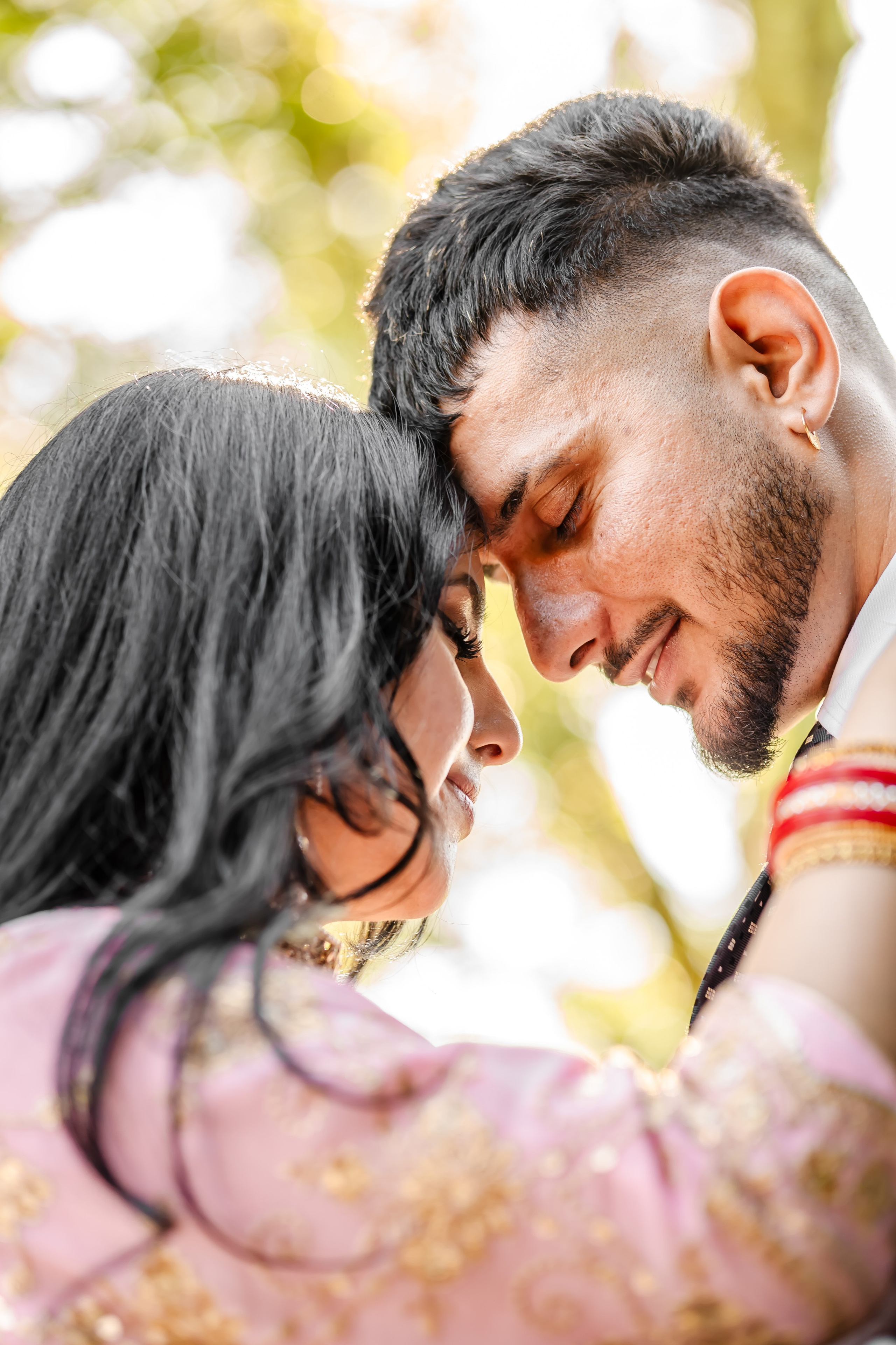 a couple standing with heads close