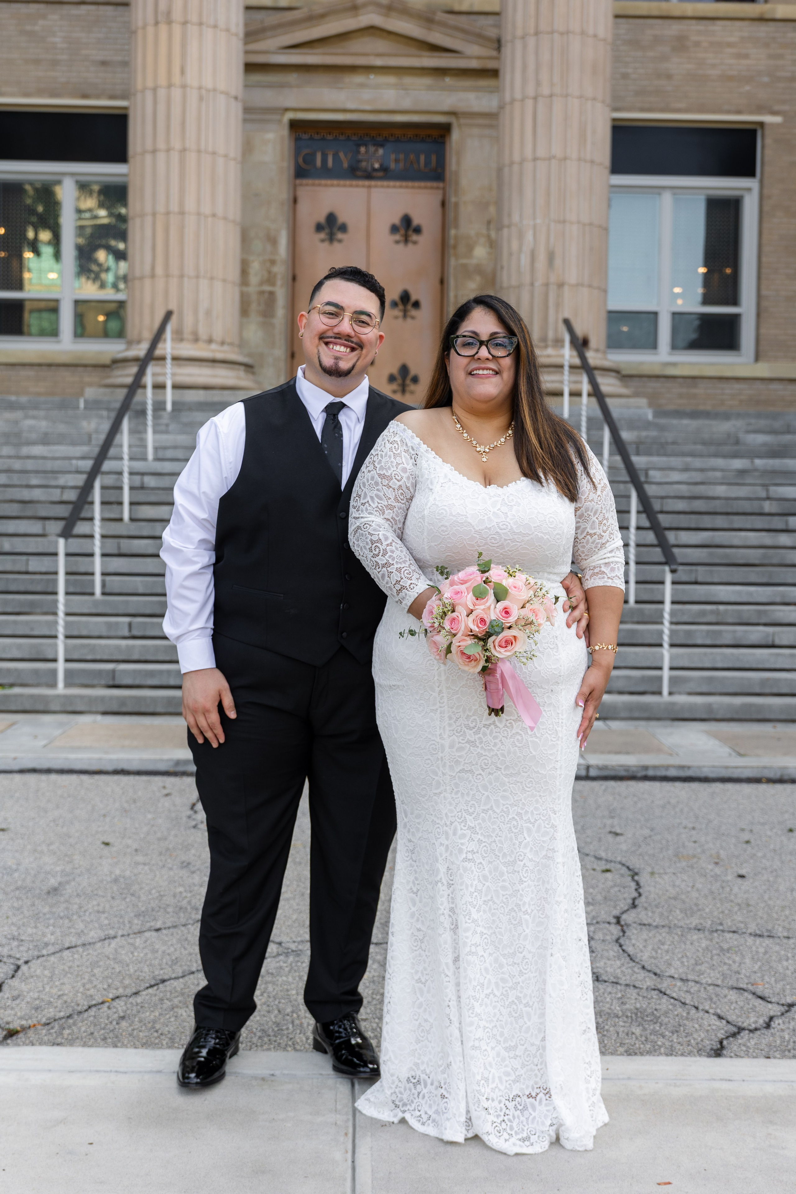 Bride and groom kissing outside New Rochelle City Hall after their wedding ceremony in New York