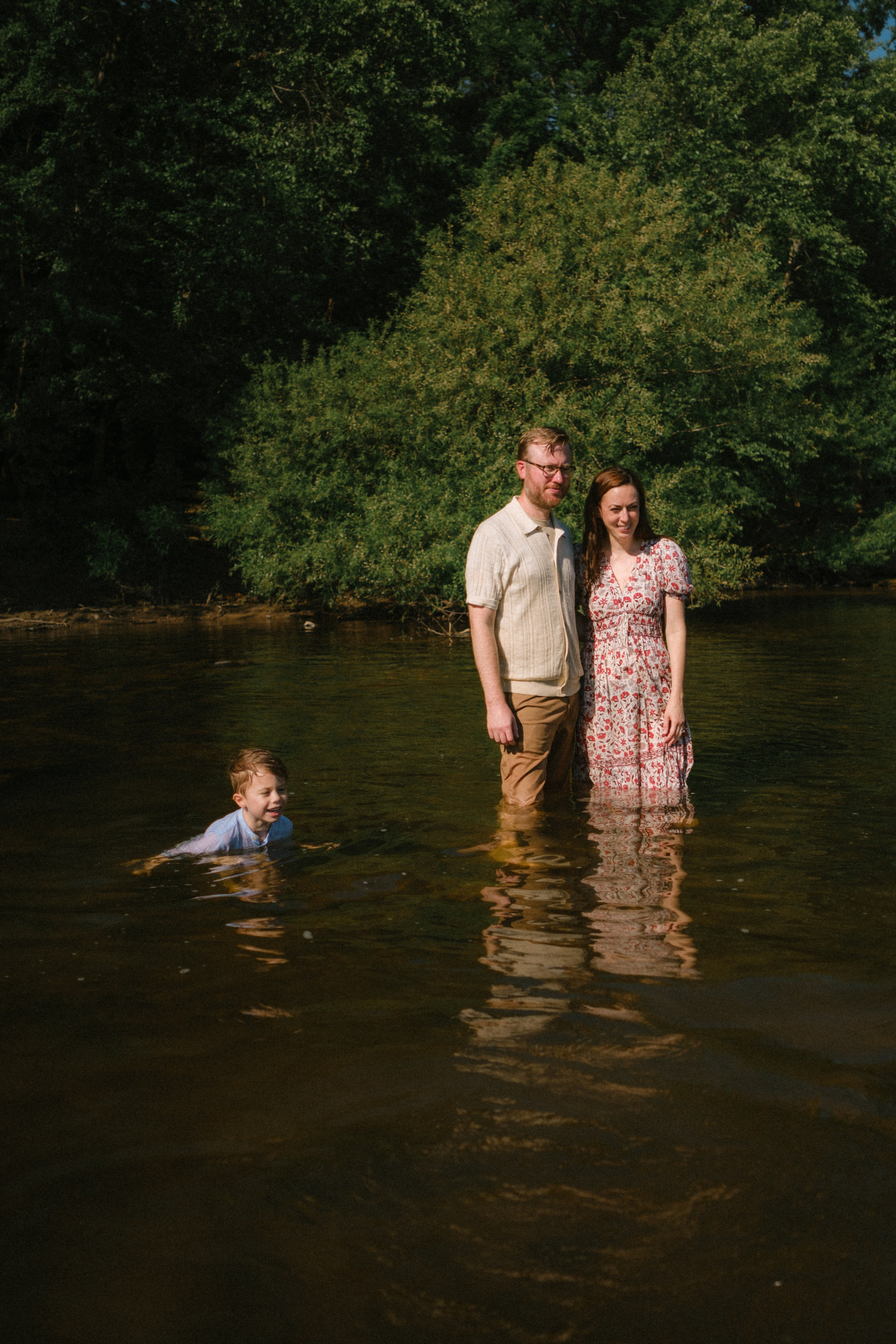 Beautiful, cinematic family portrait capturing a genuine, unposed moment on the river rocks in Richmond, VA