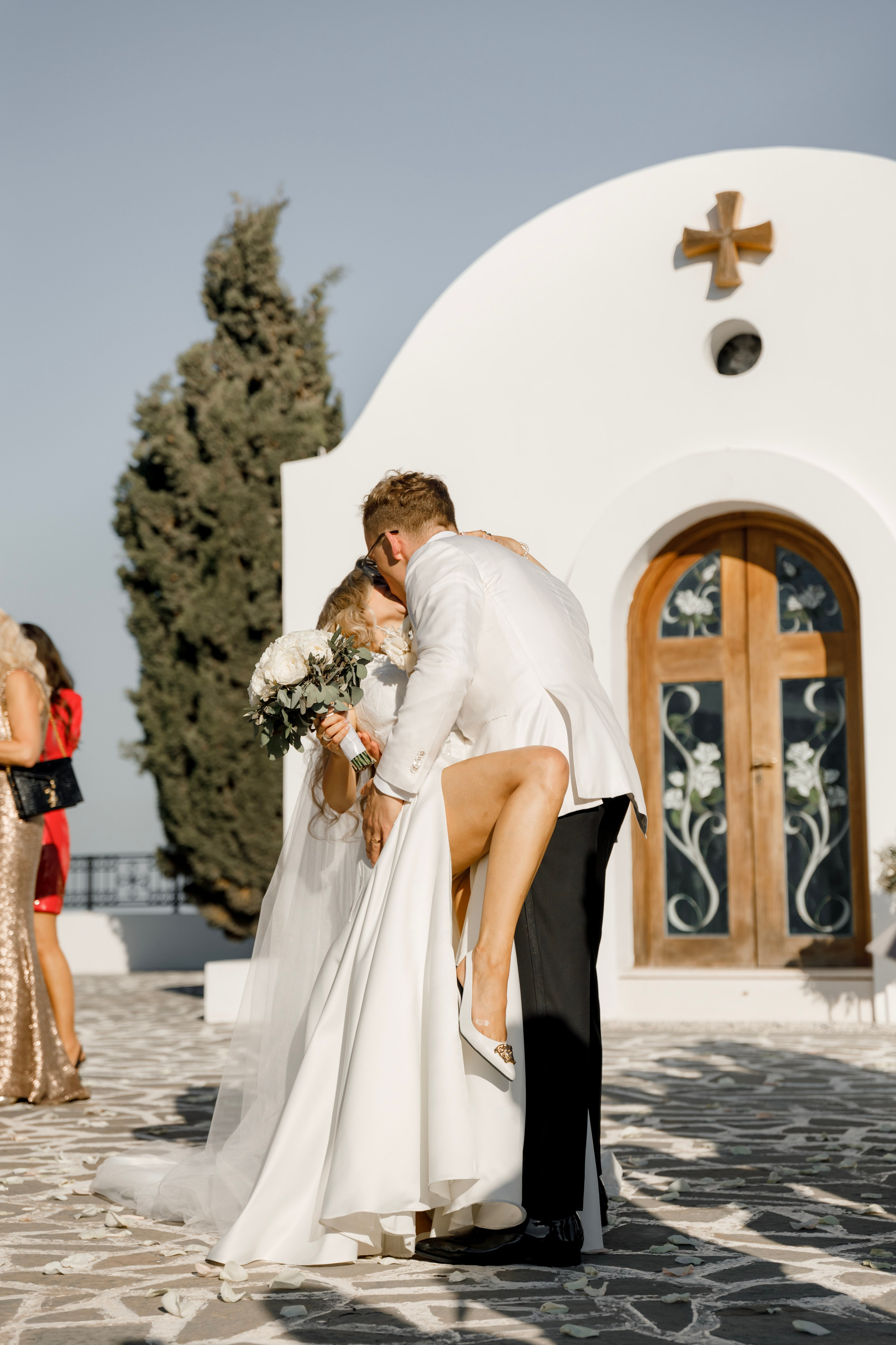 Groom is kissing the bride. Church Agia Sofia in luxury hotel Esperos Village. Rhodes Greece